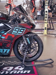 A racing motorcycle stands on its maintenance stand.