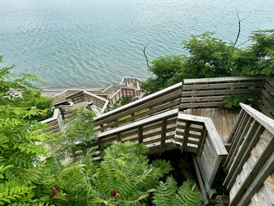Wooden stairs lead down to a beautiful lake