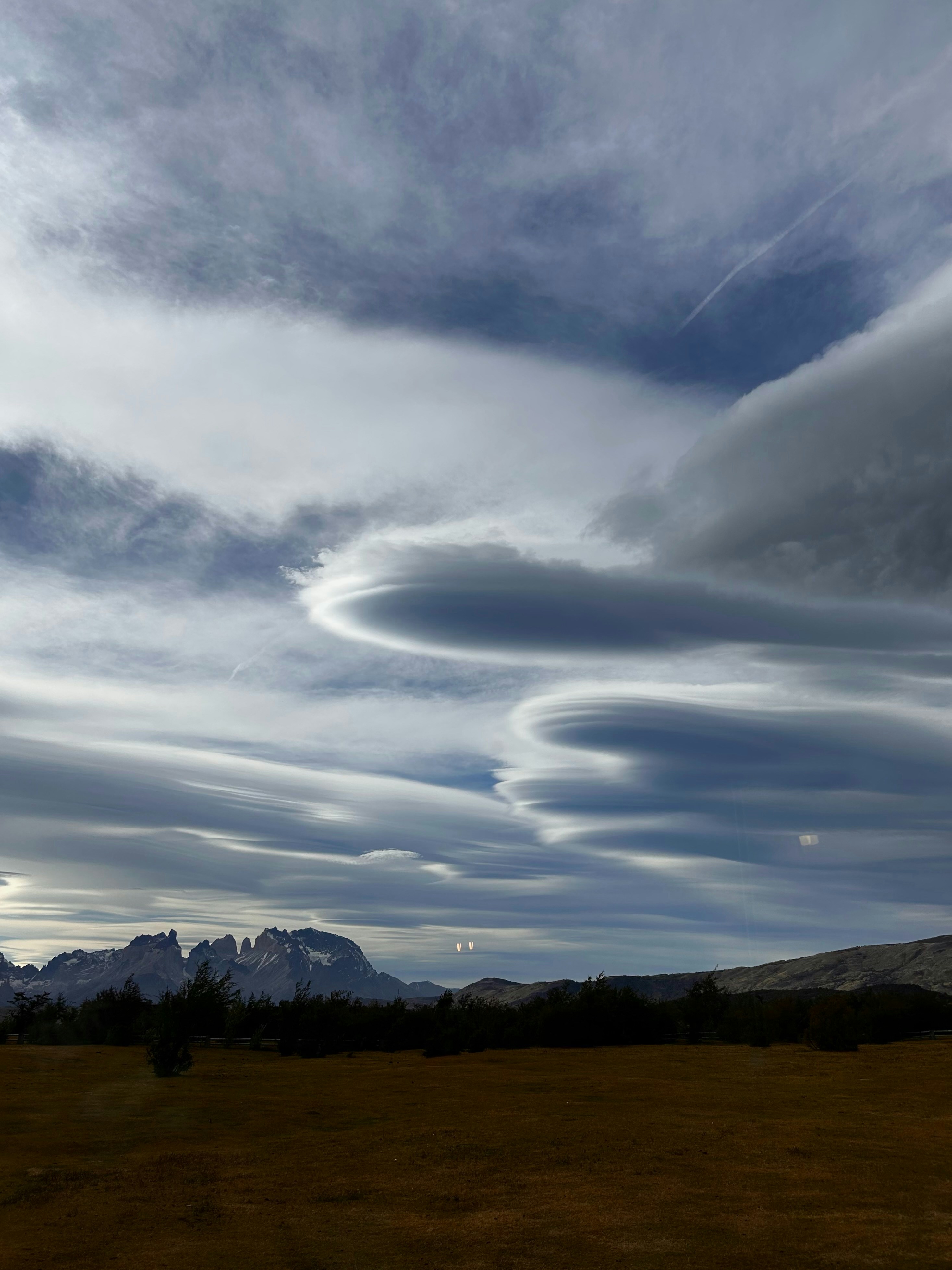 Amazing clouds hover above a beautiful landscape.