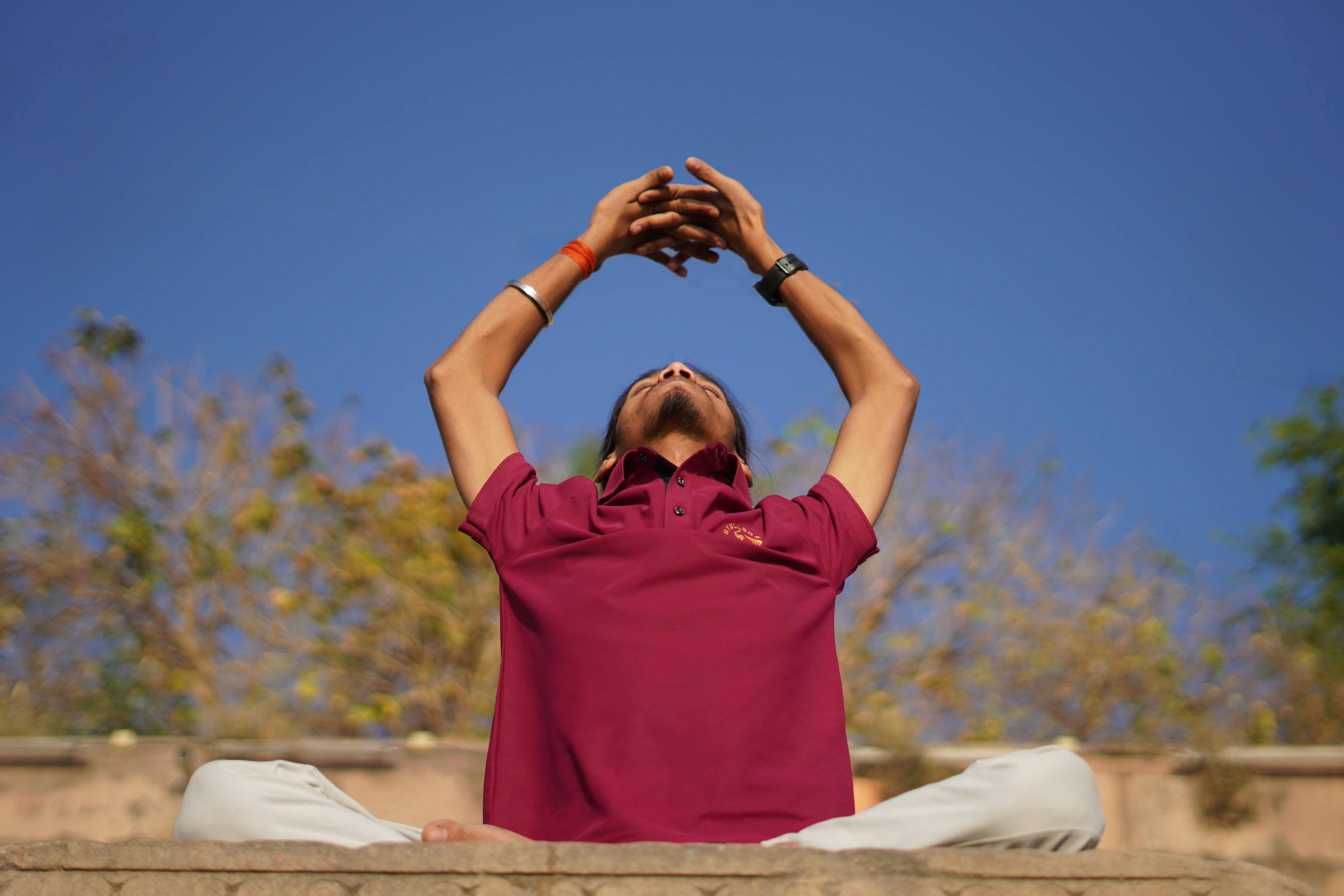 person meditating or exercising outdoors - addiction recovery
