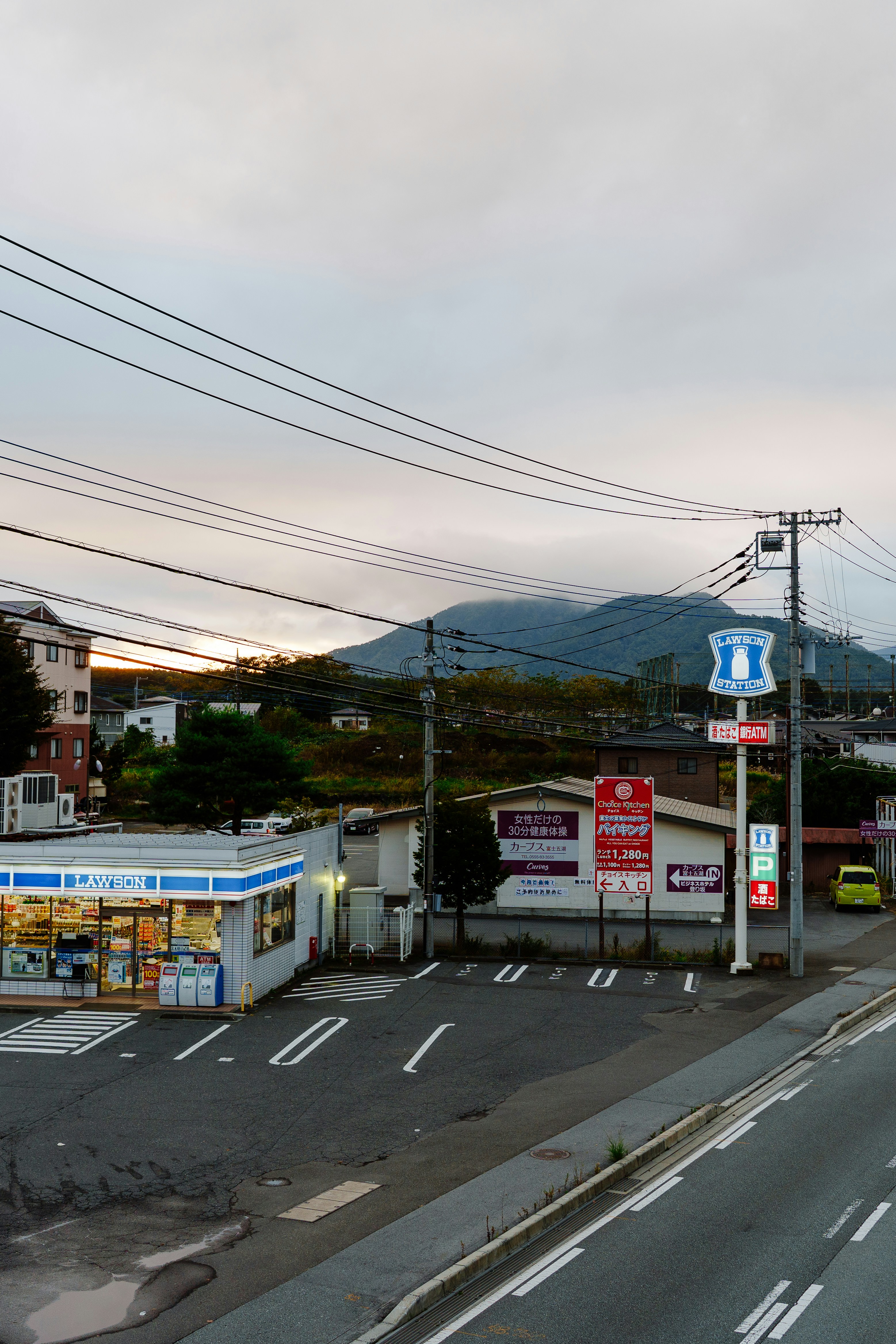 A convenience store in a rural japanese landscape.