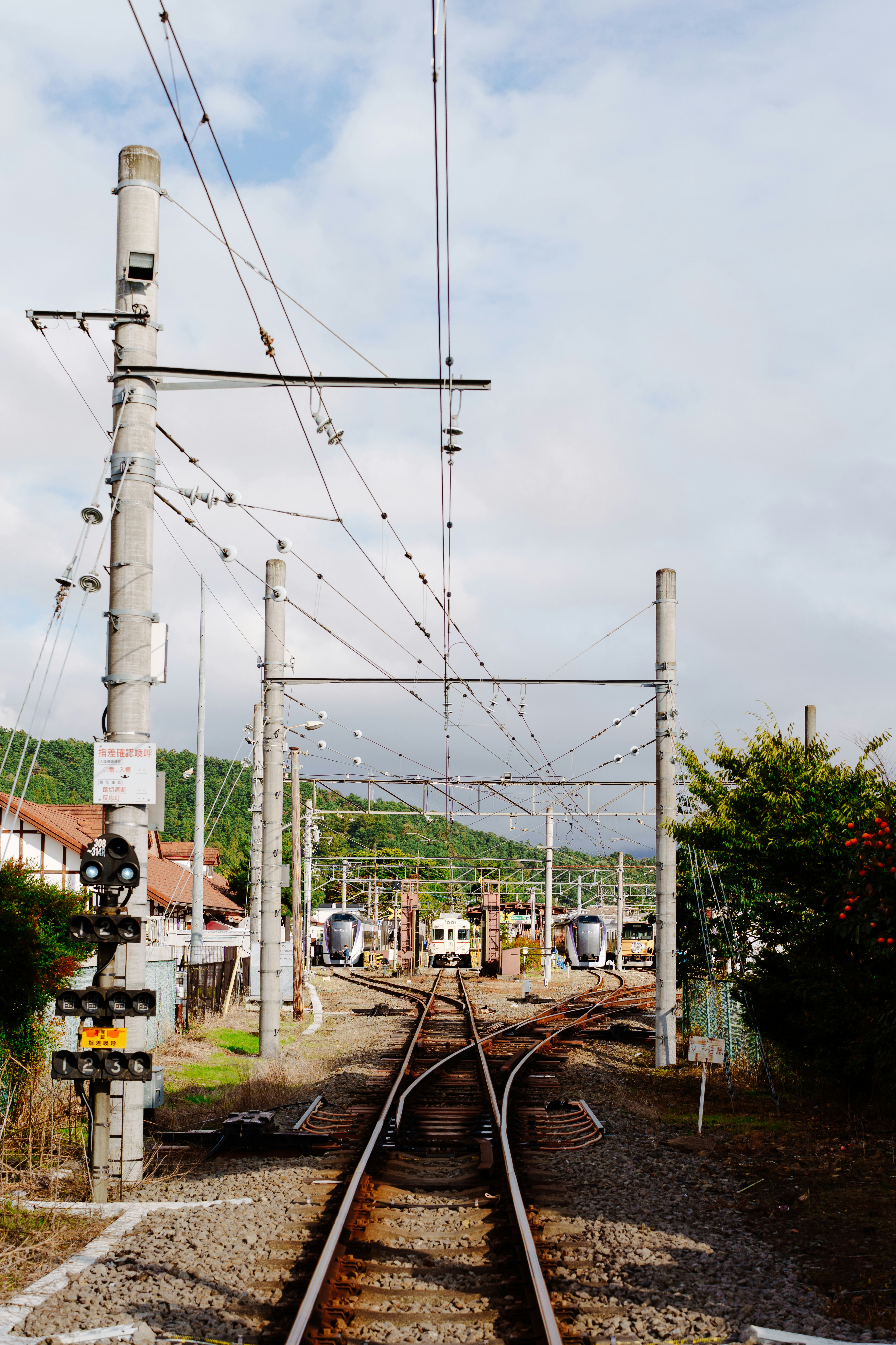 Railroad tracks split toward a train station.