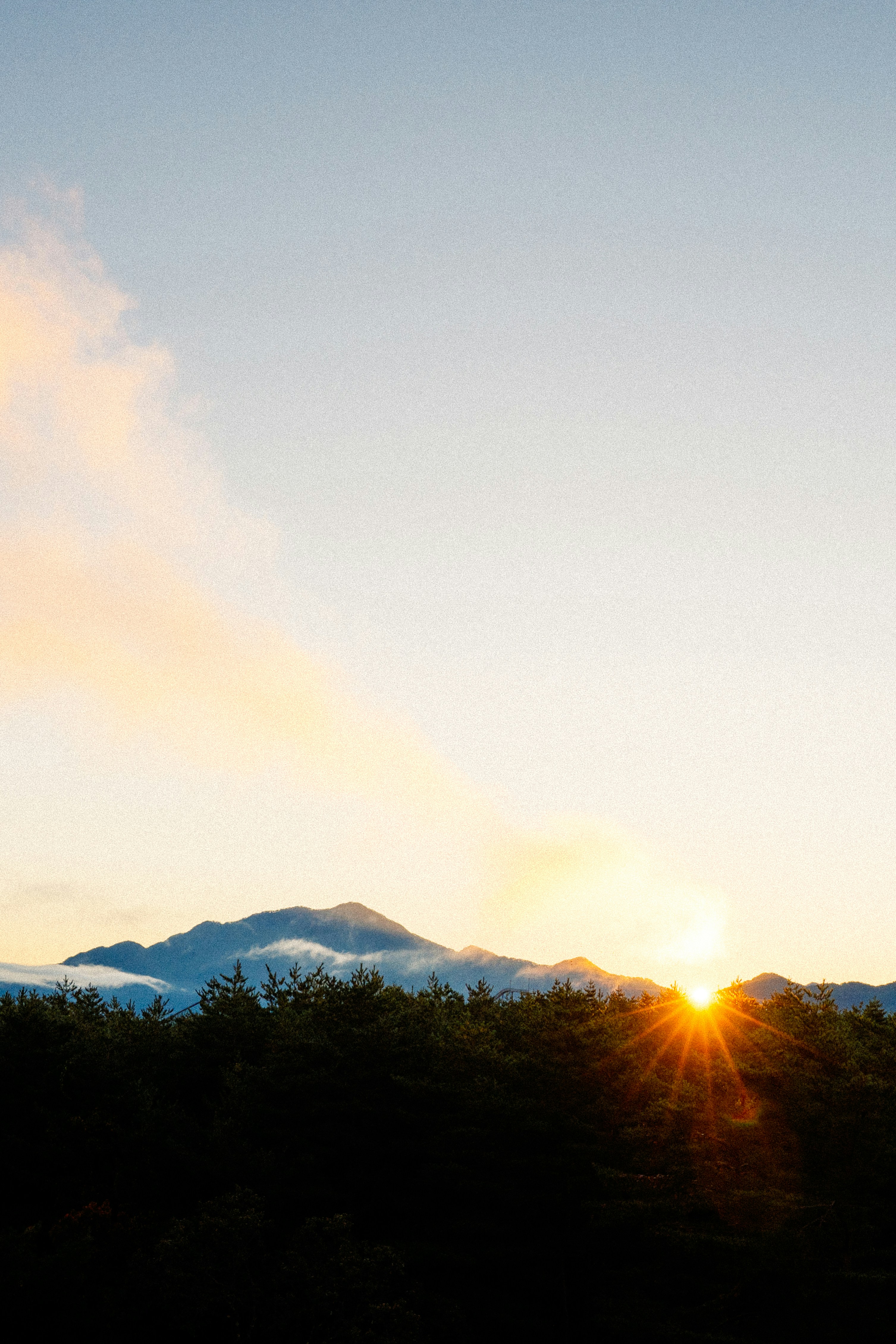 Sunrise peaks over a mountain range.