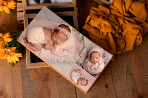 Newborn photos displayed in a photo album.