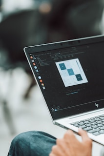 A laptop displays data analysis on its screen.