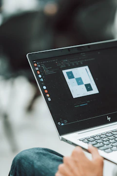 A laptop displays data analysis on its screen.