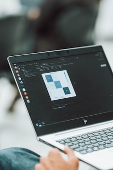 A laptop displays a statistical data table.