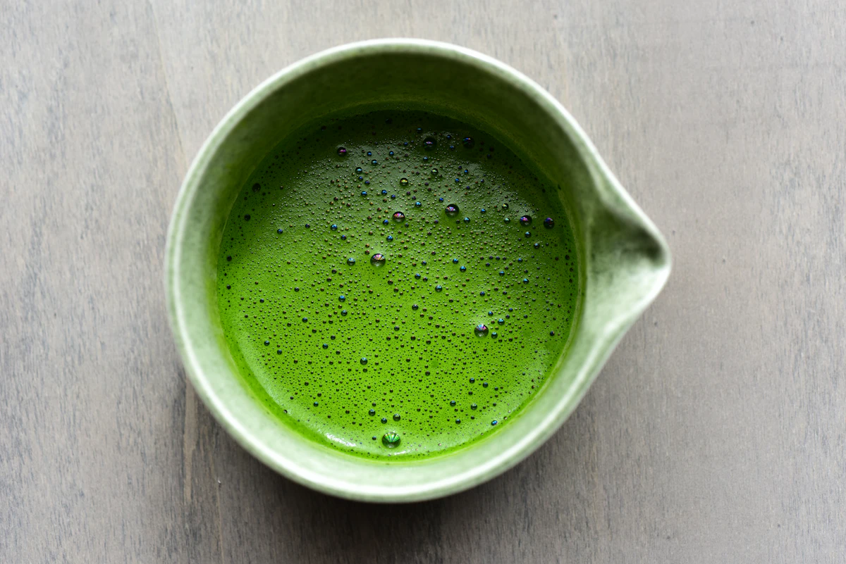 Matcha tea in a green ceramic bowl