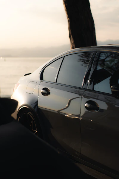 A sleek car reflected in the sunlight.