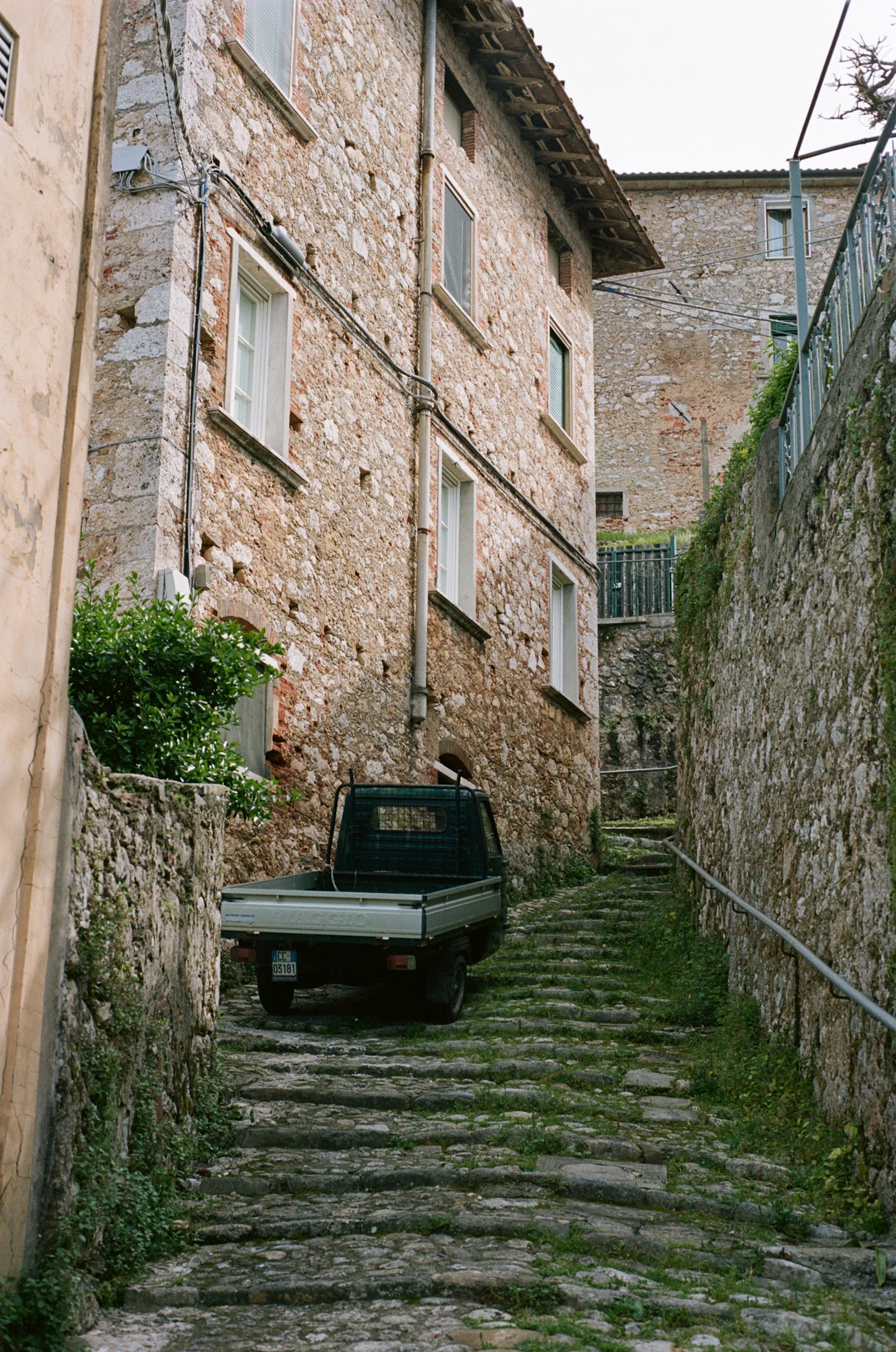 A stone road leads through an old Italian town