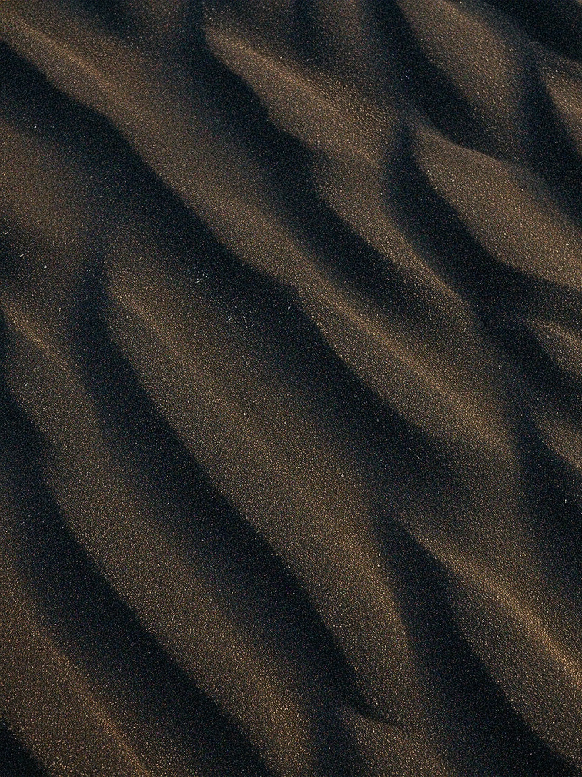 Dark sand ripples create an interesting pattern.