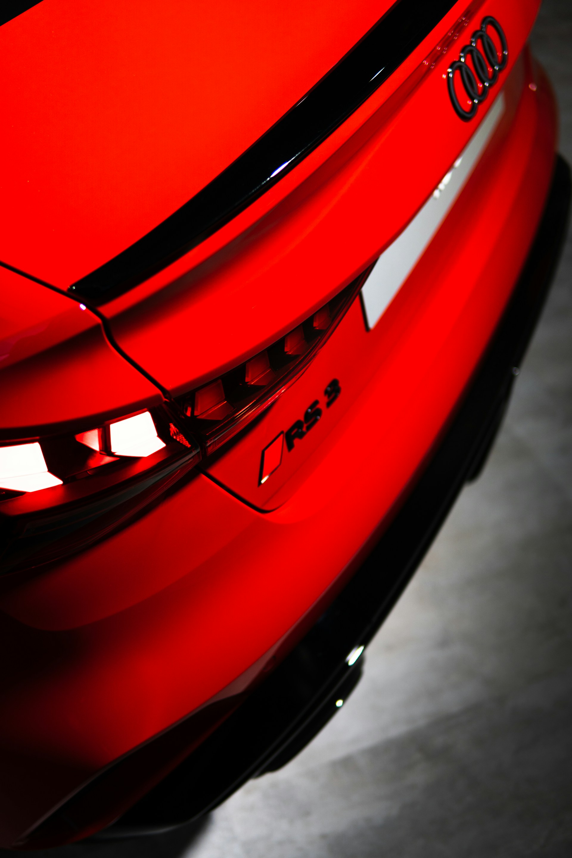 A red audi rs 3 car rear is shown.