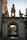 A stone archway leads to a gated entrance.