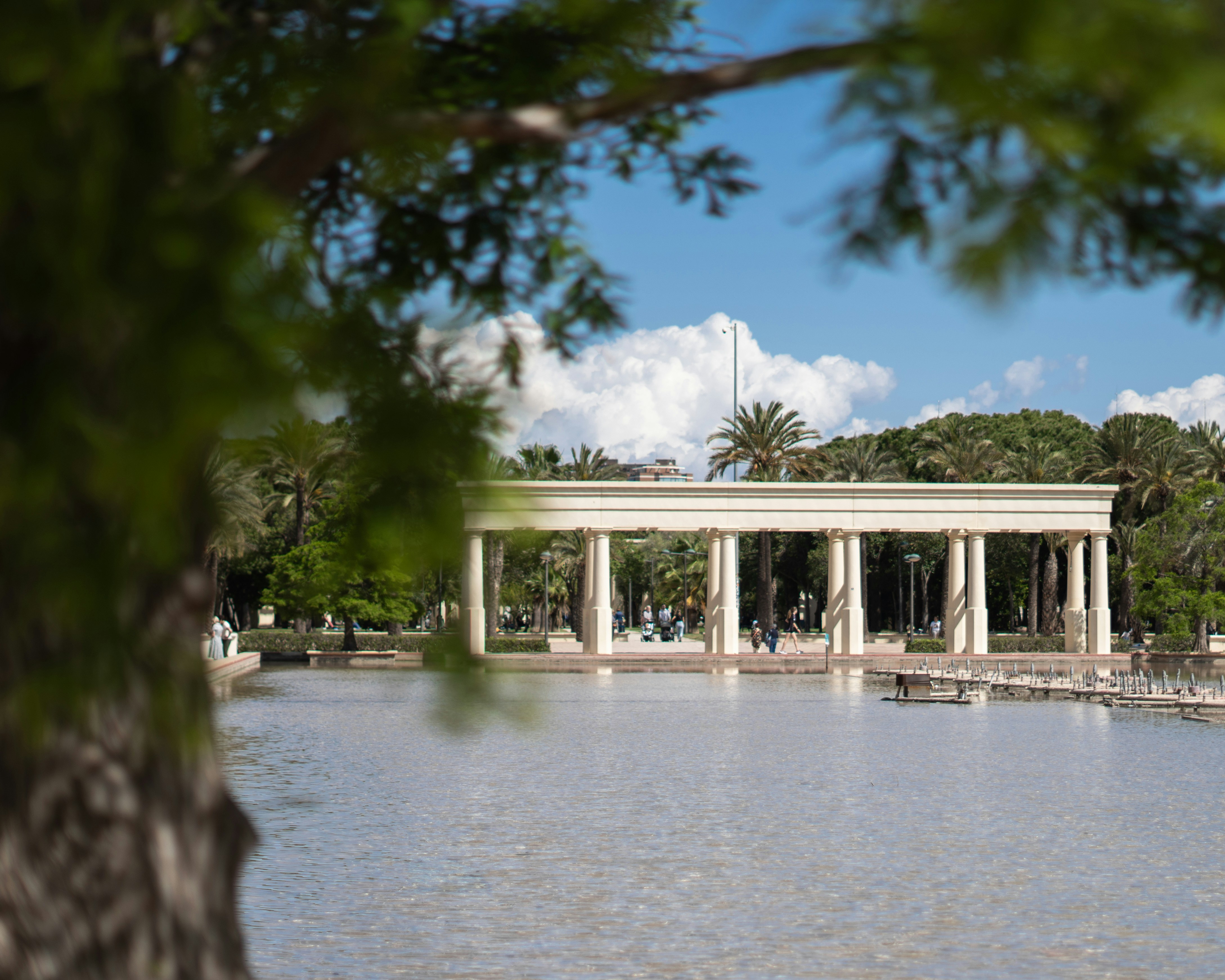 A beautiful building sits across the reflective water.