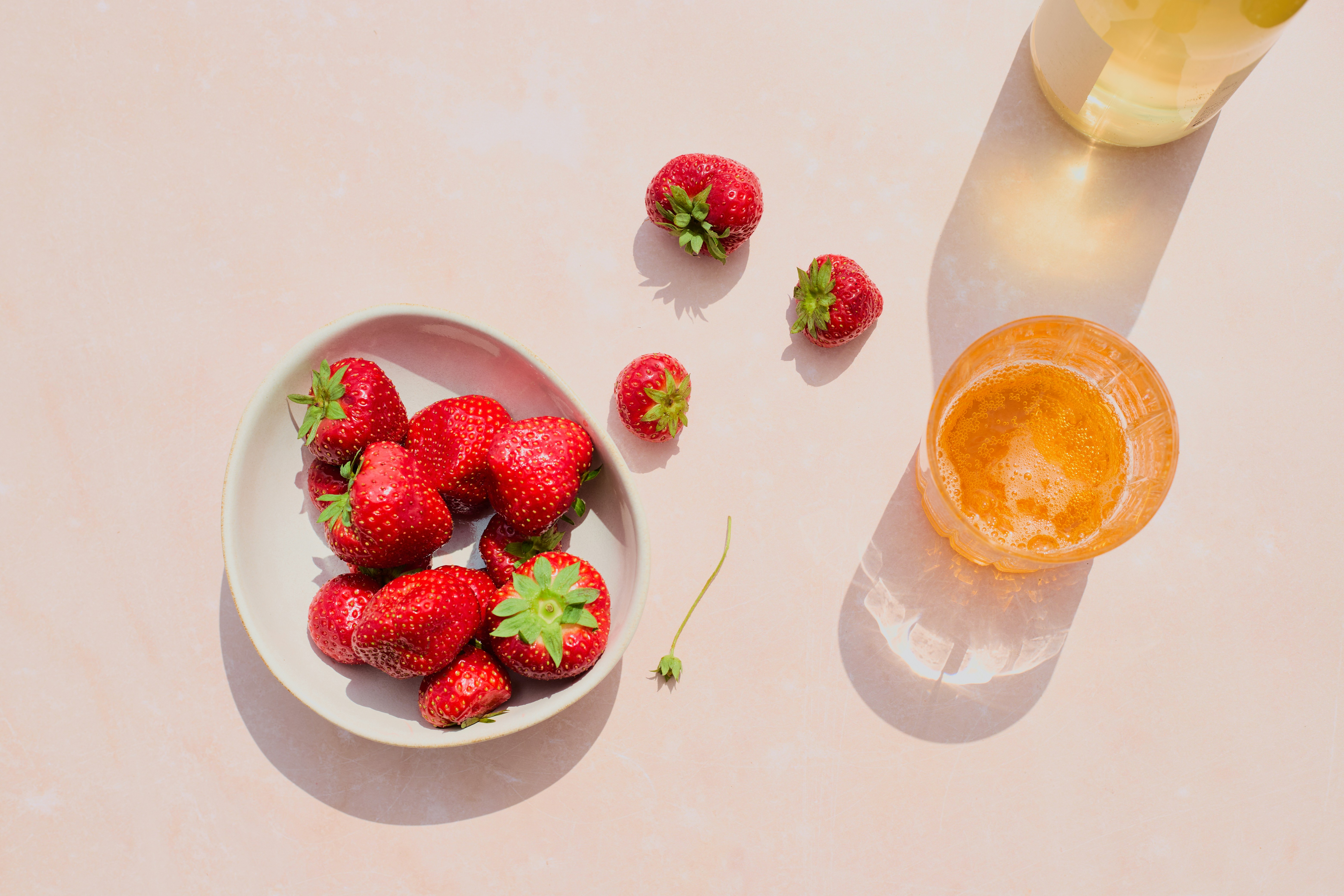 Fresh strawberries and drinks are displayed.