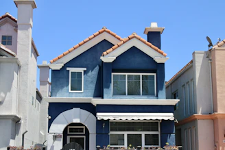 A beautiful blue house on a sunny day.
