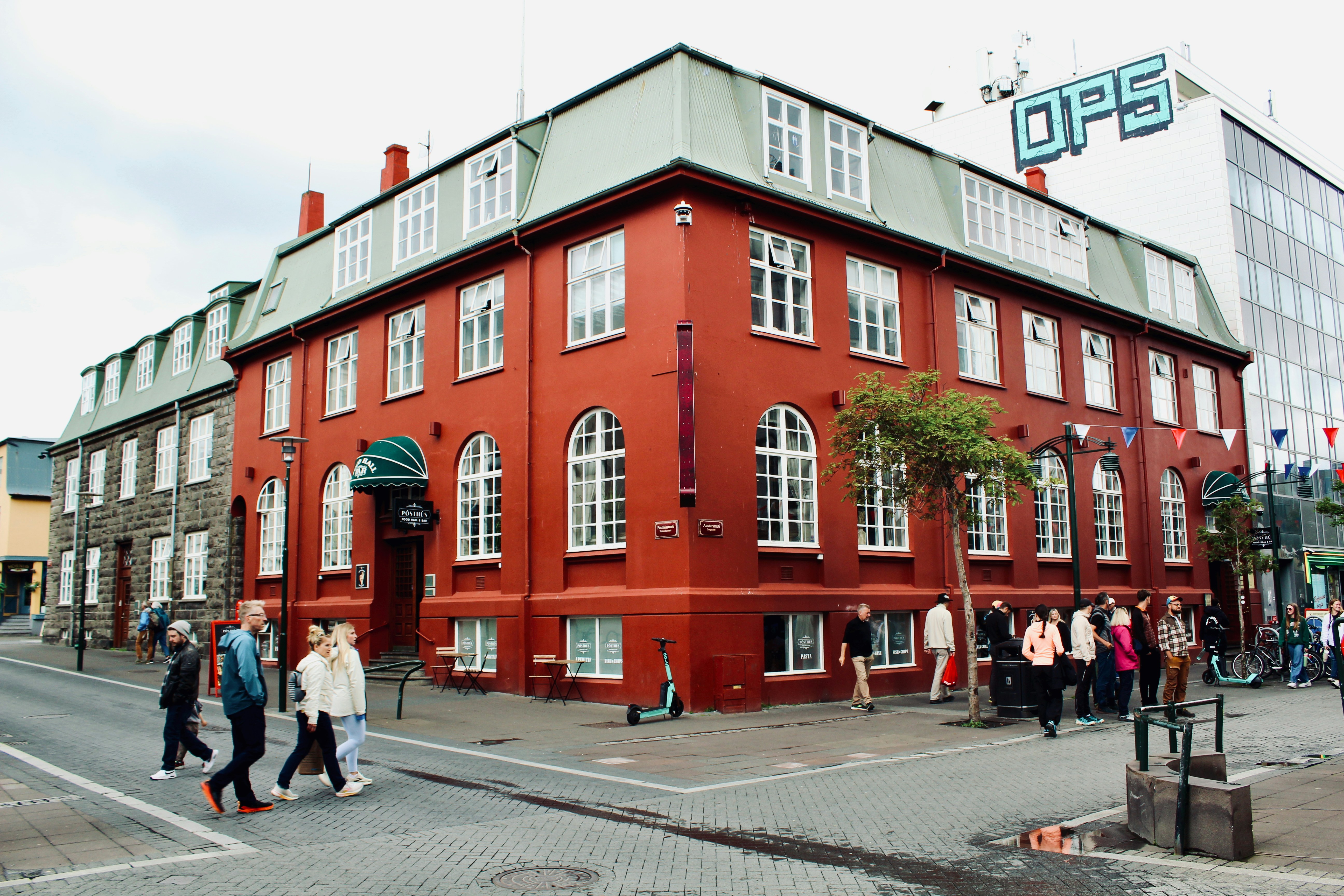 A red building with people walking around it.