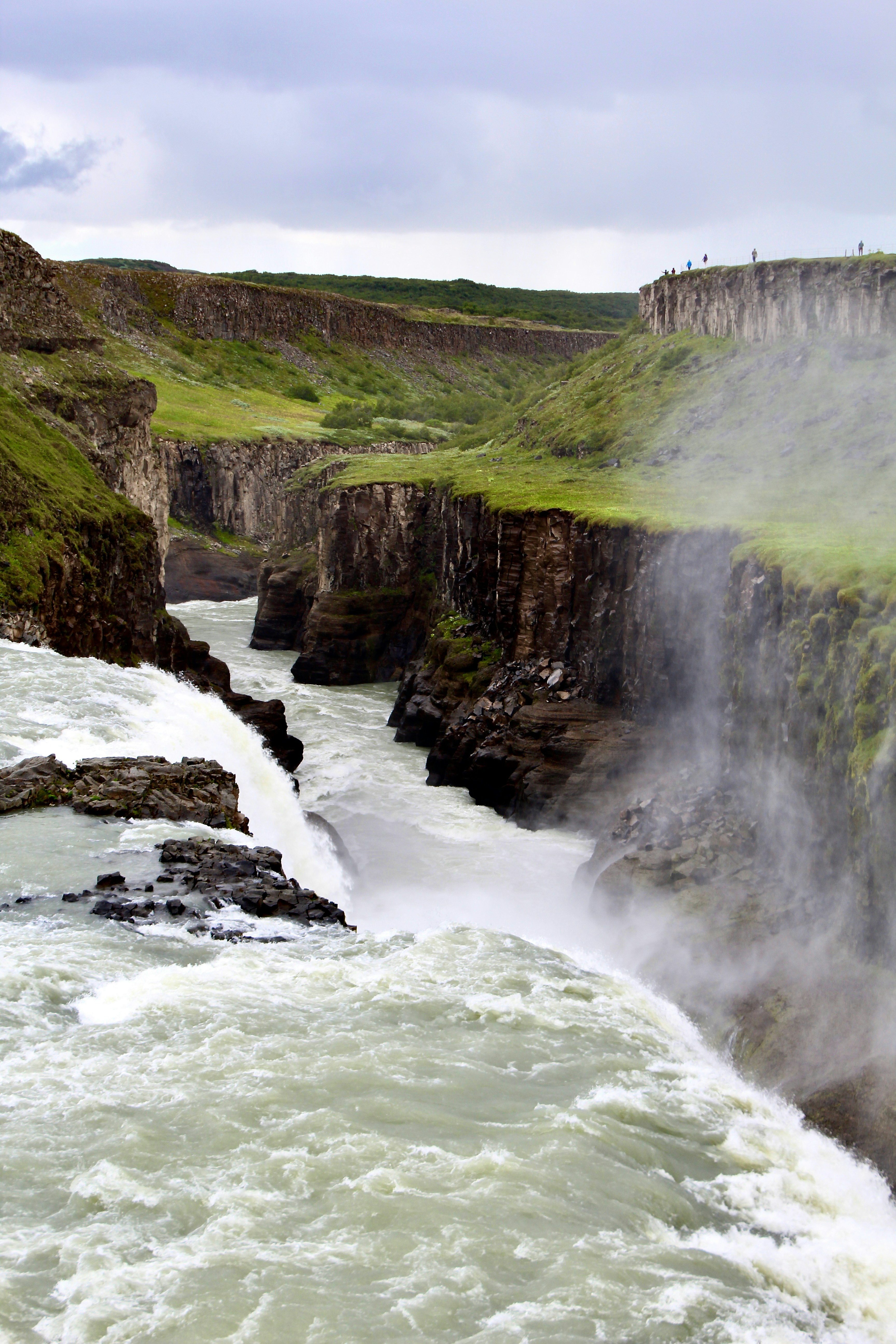 A powerful waterfall cascades through a canyon.