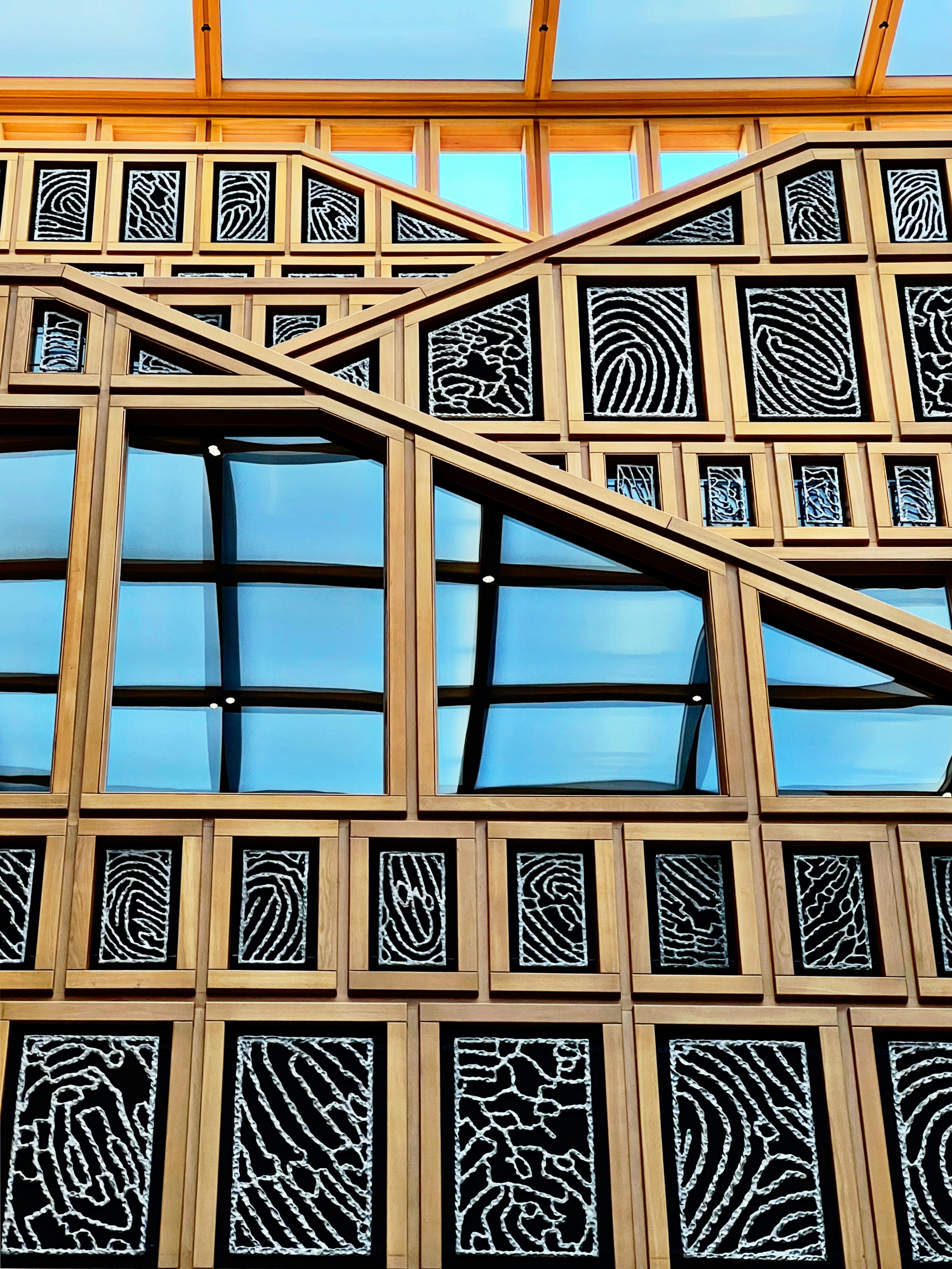 Wood and glass wall with intricate fingerprint patterns.