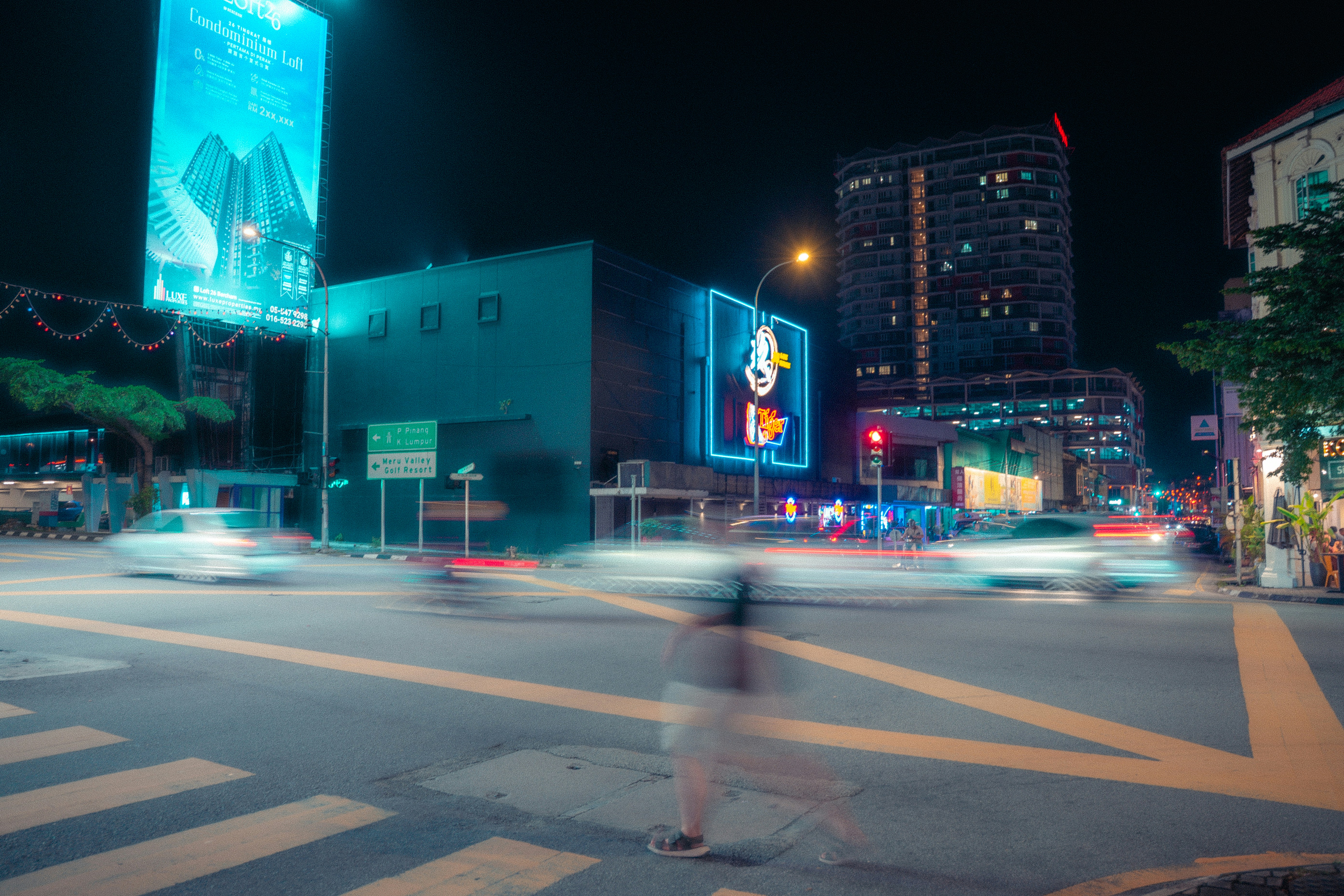 Nighttime city scene with blurred car lights.
