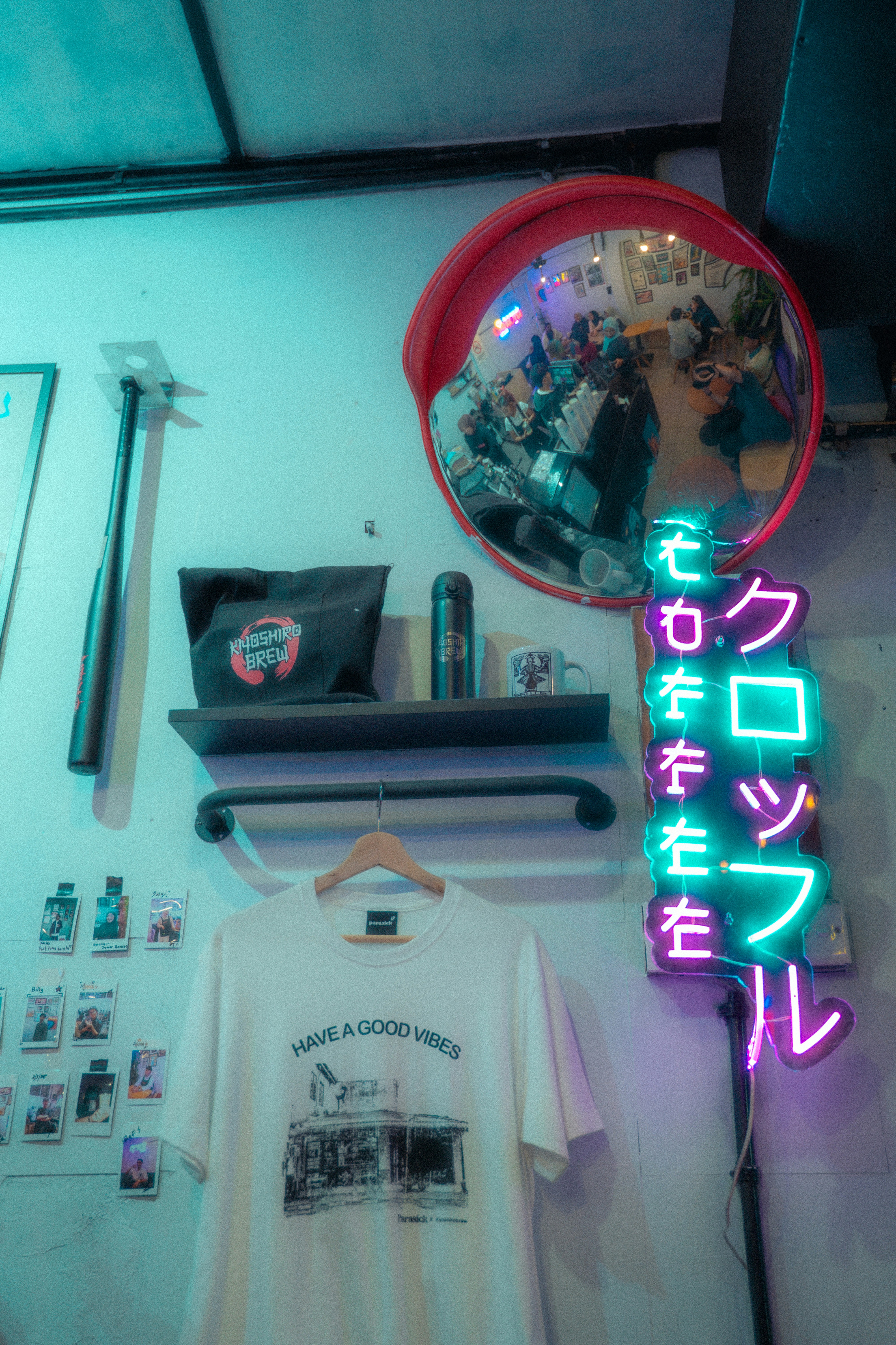 A neon sign and various items adorn a wall.