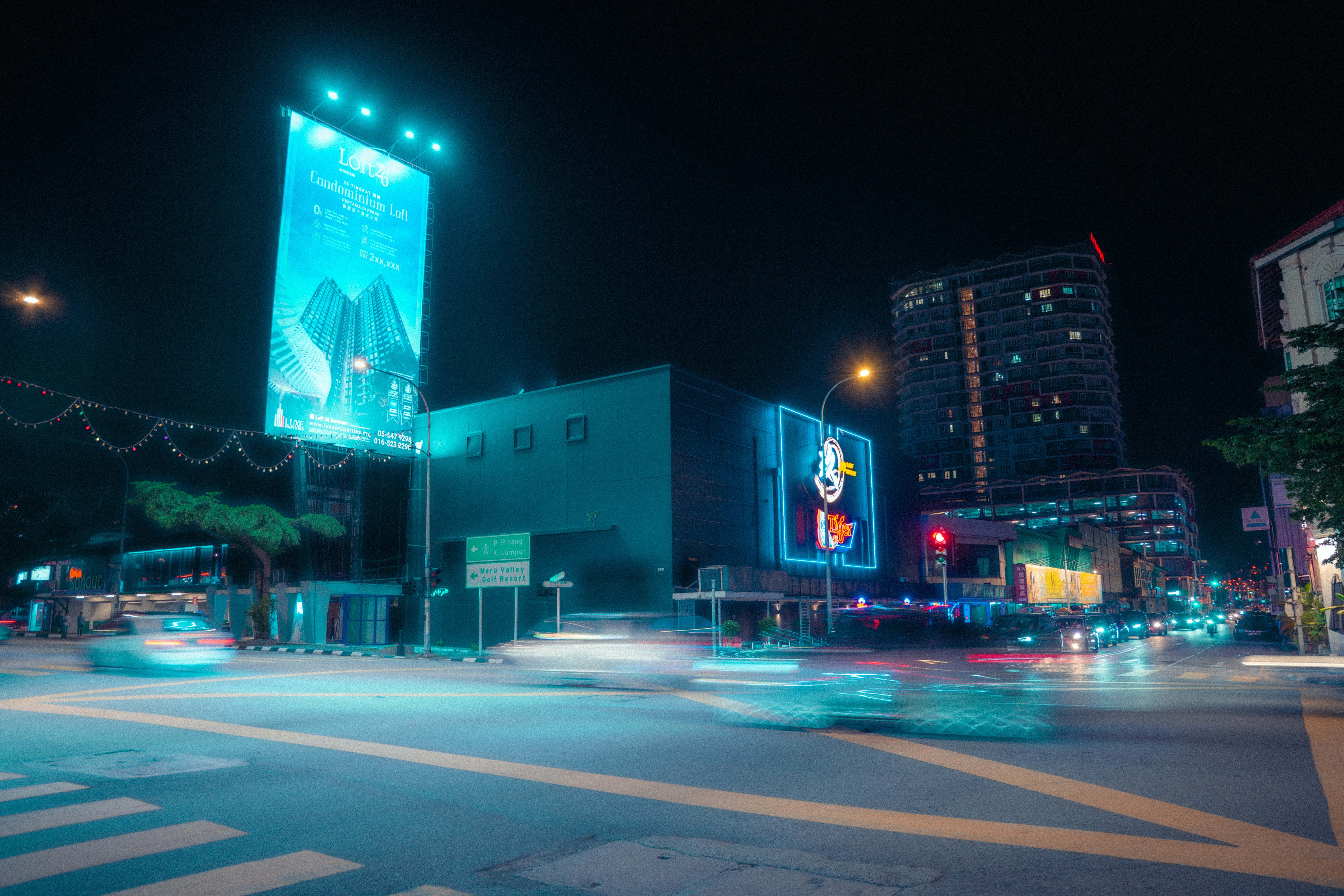 Cityscape at night with blurred car lights.