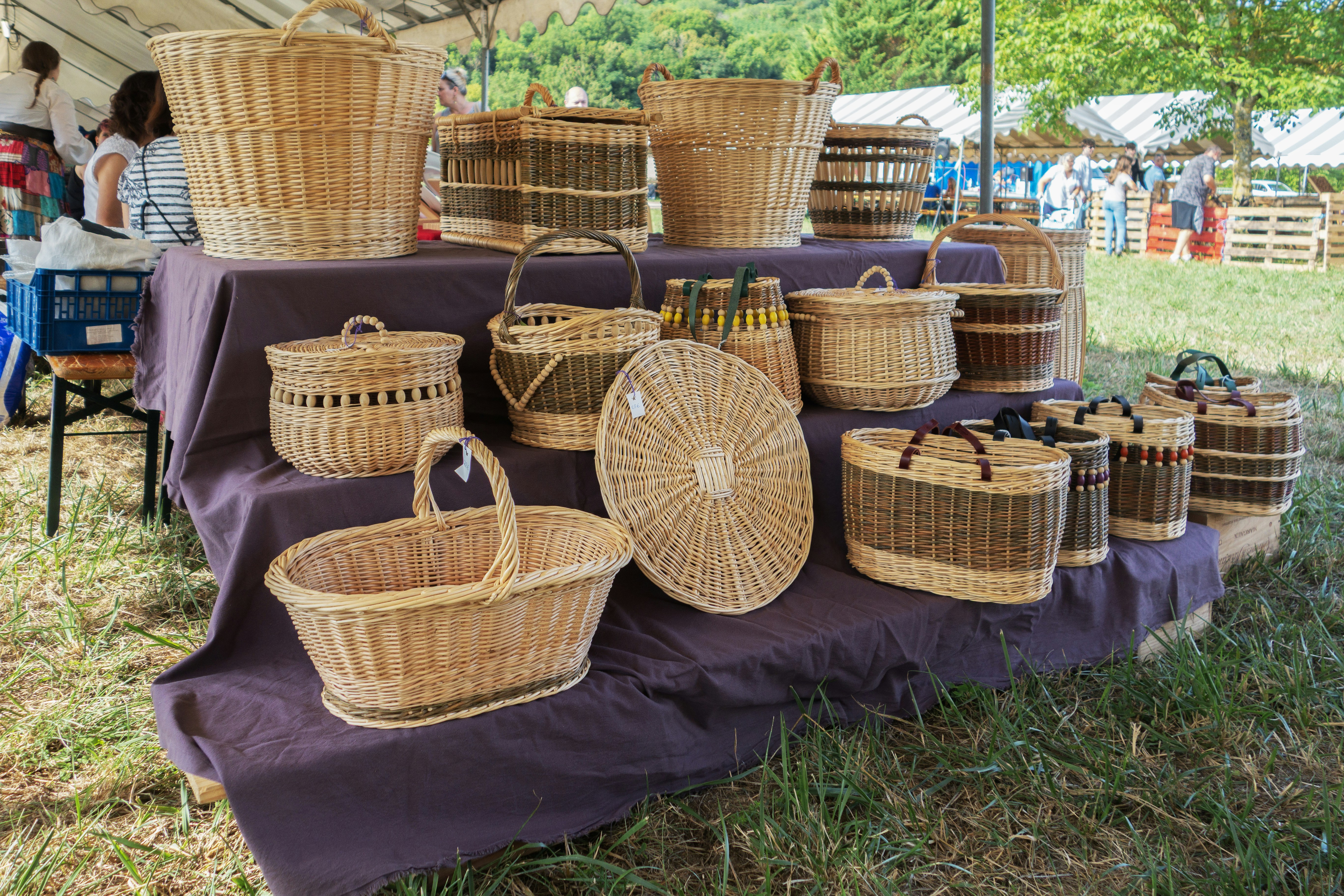 Woven baskets are displayed on a purple table.