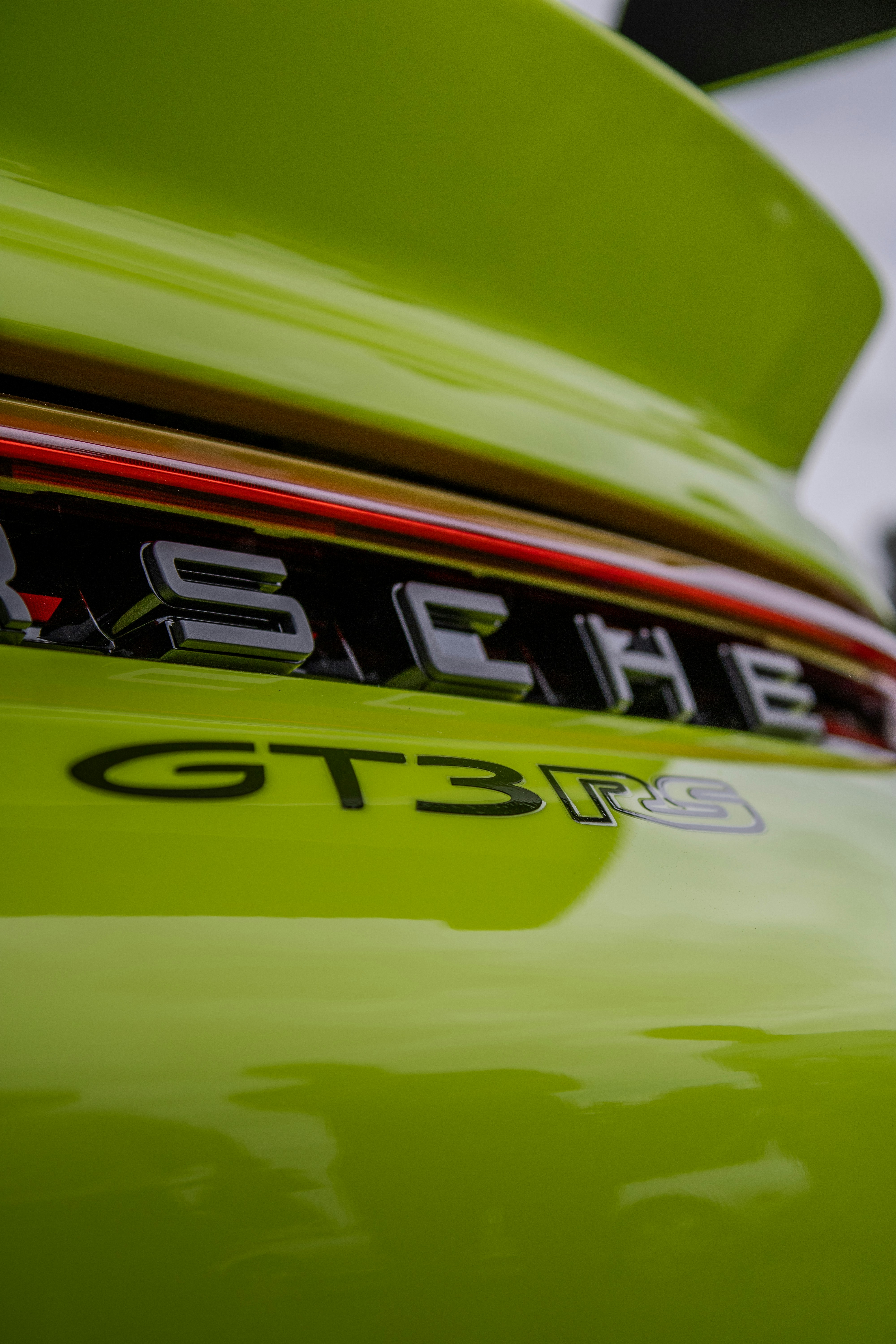 Das Porsche gt3rs-Emblem ist auf einem grünen Auto zu sehen.