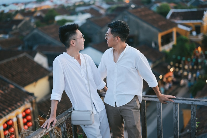 Two men enjoy the evening city view.