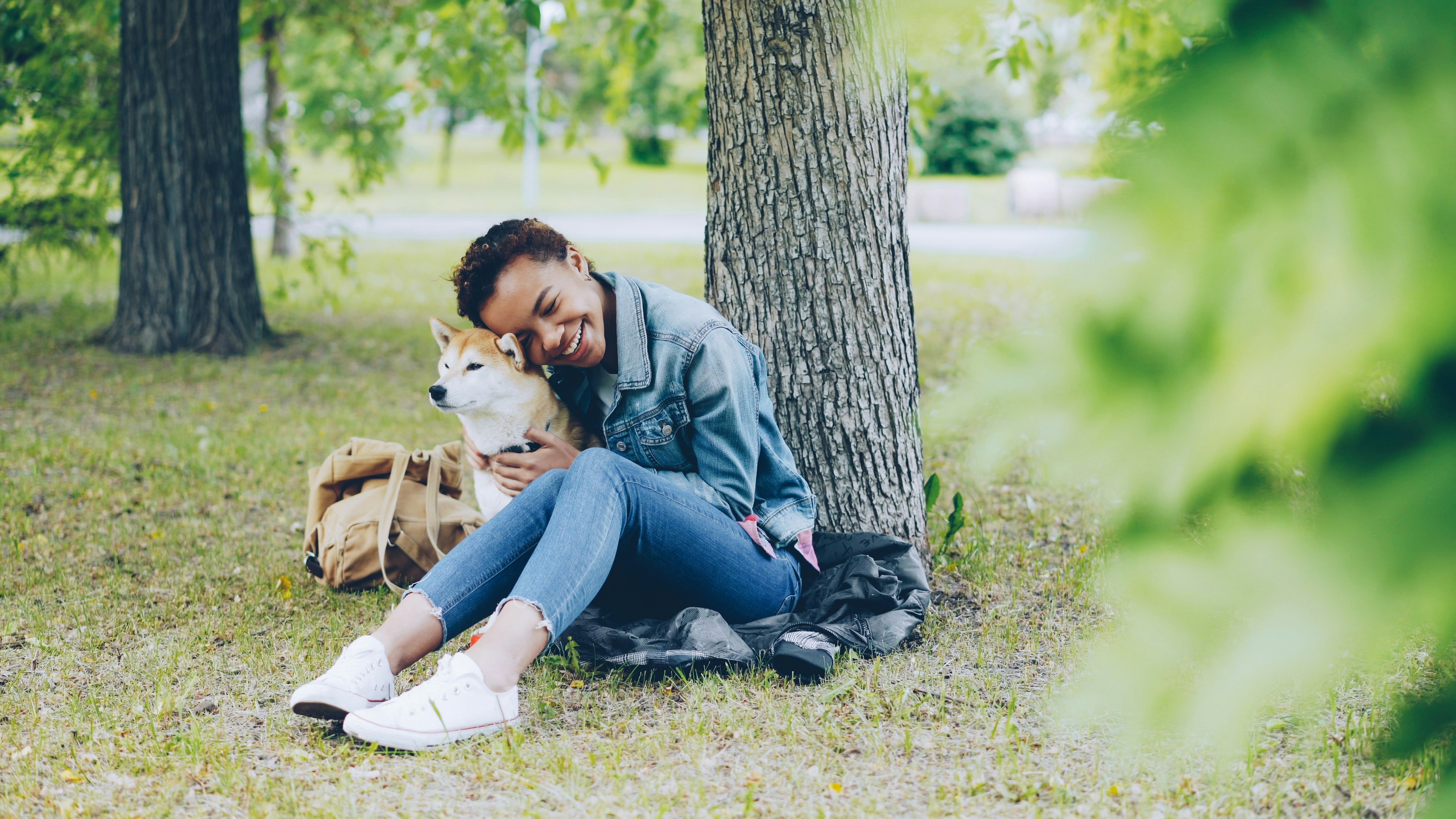 Girl cuddling Shiba Inu dog