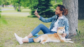 Woman taking a selfie with her dog in the park.