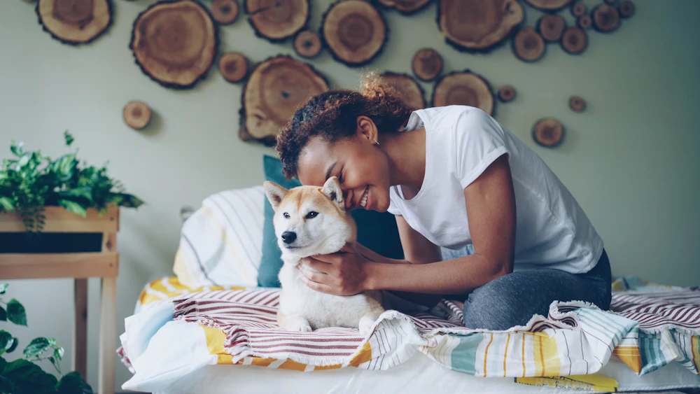 Resident cuddling her dog at home