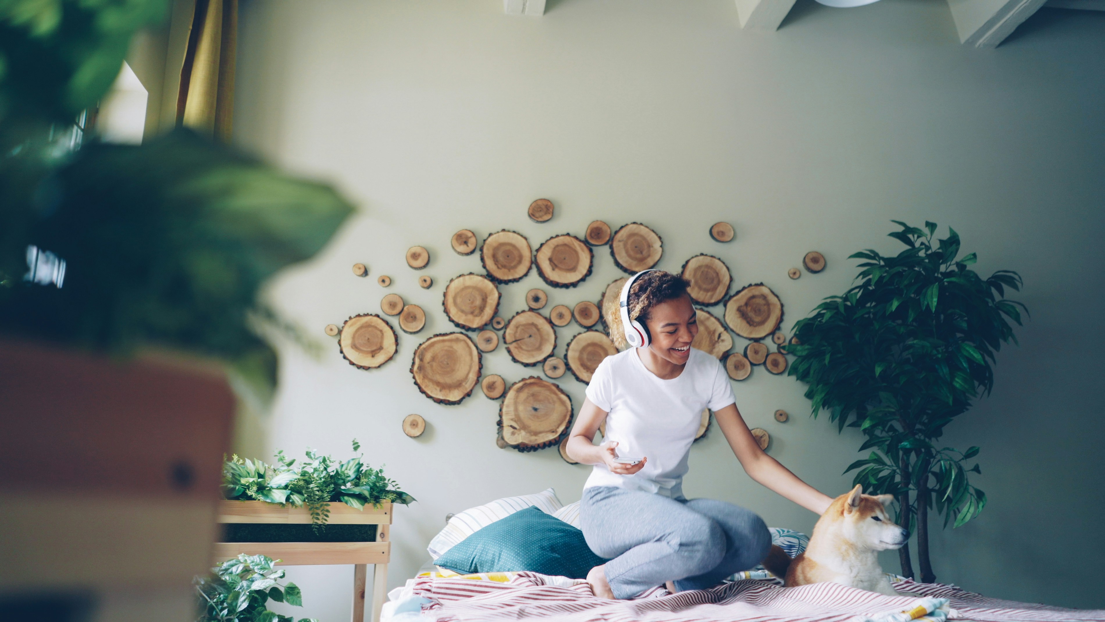 Woman listens to music and pets her dog.