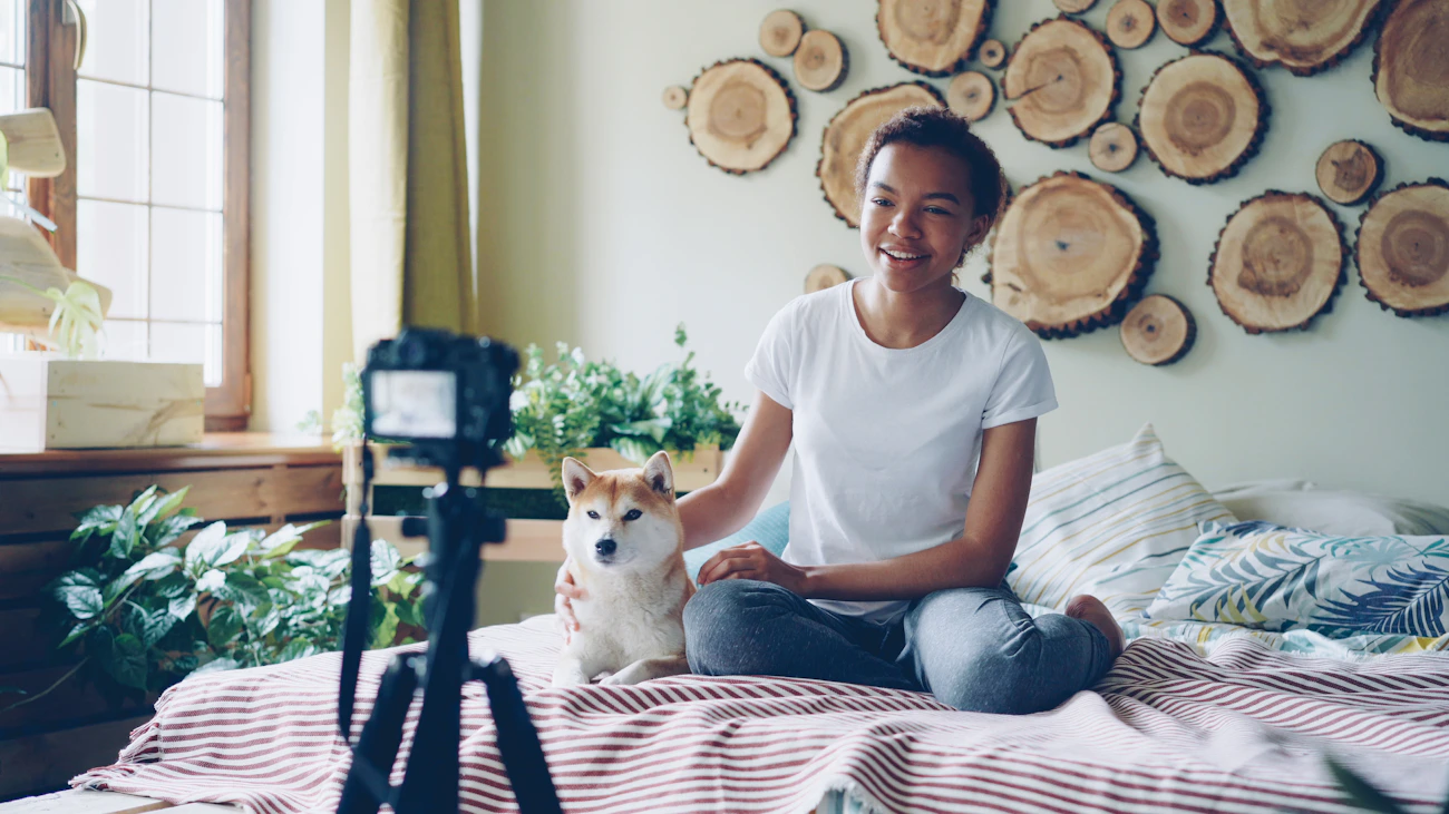 Pet owner using a home camera with her dog