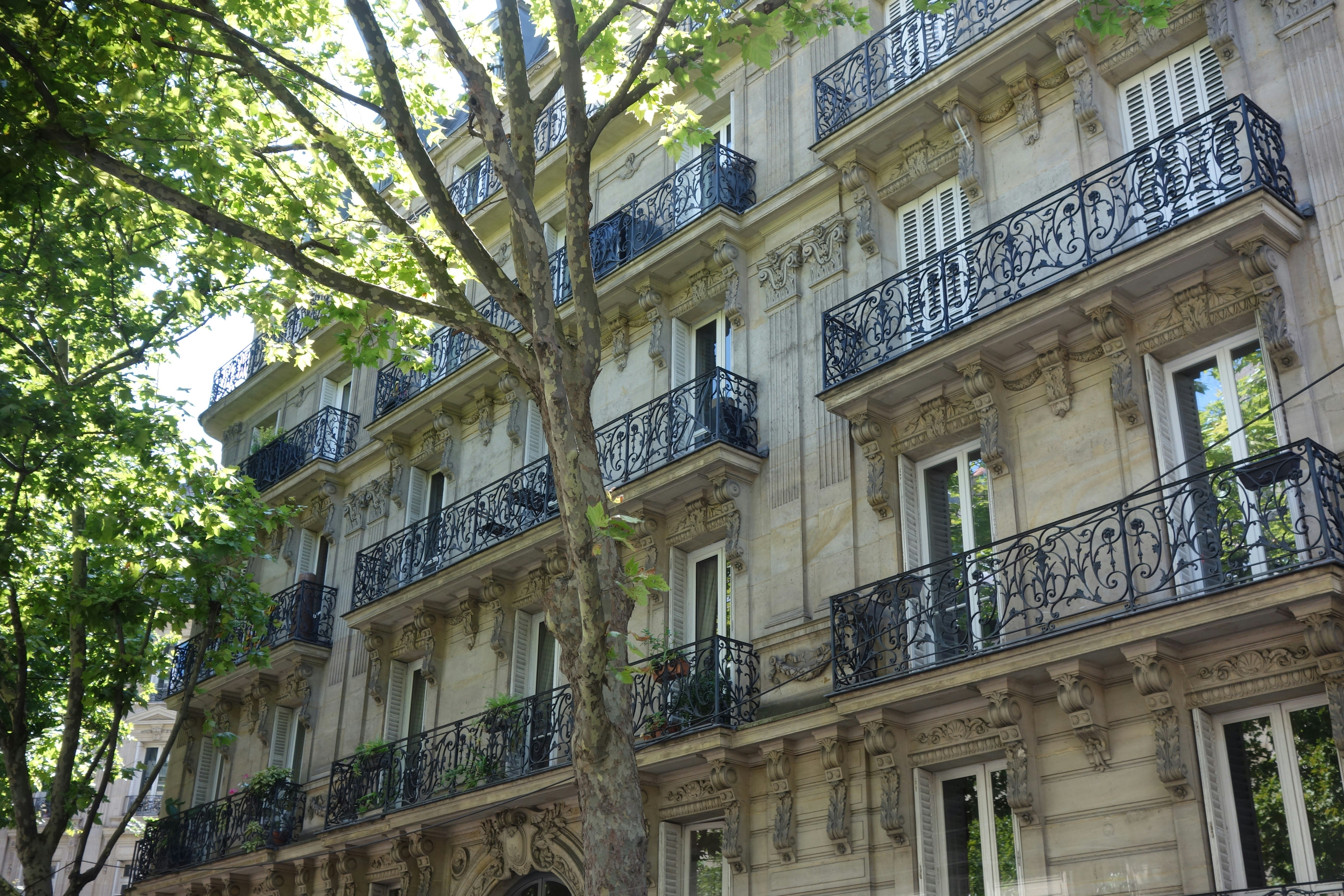 Elegant apartment building with ornate balconies.