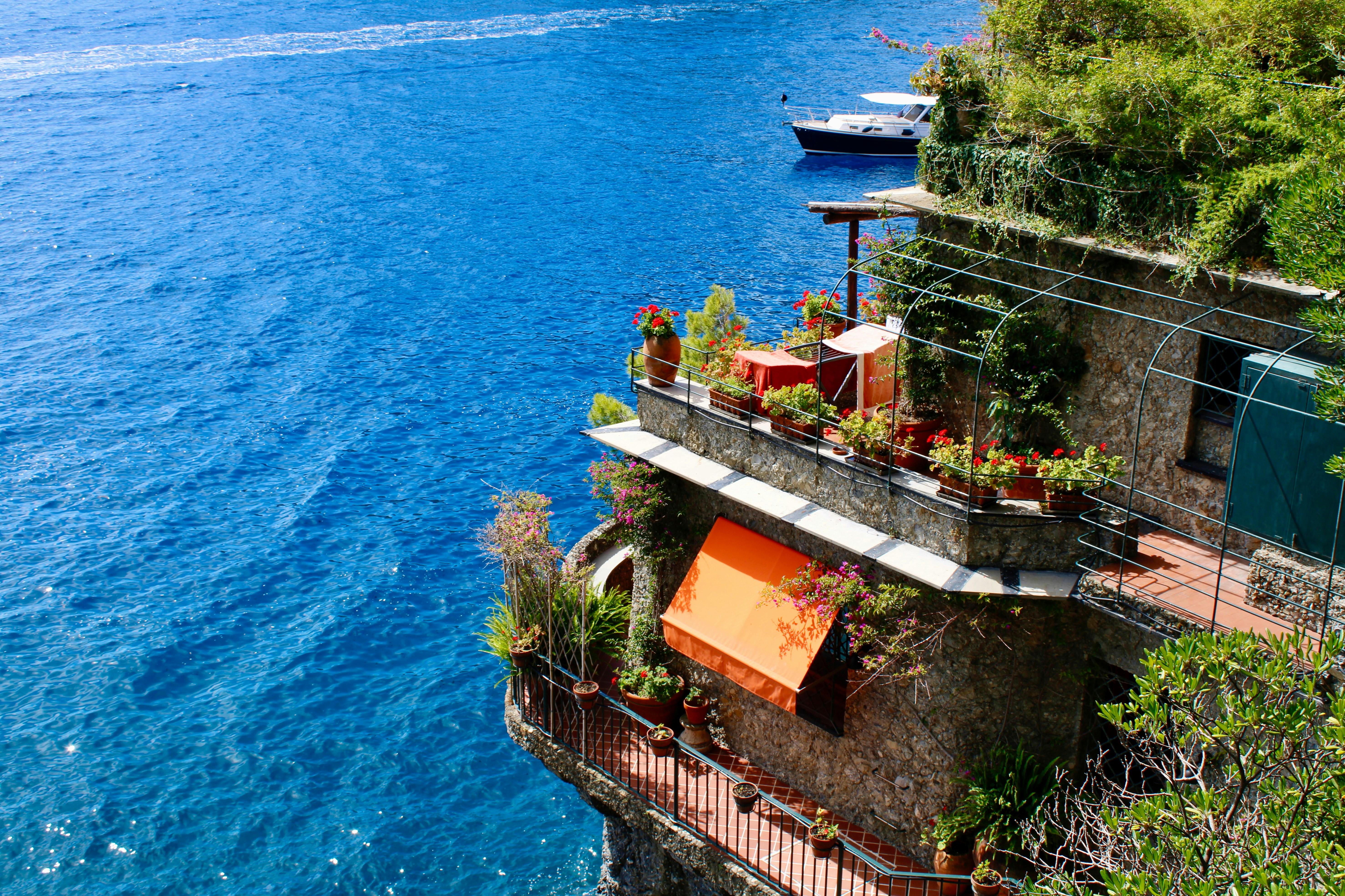 Cliffside building with a view of the stunning blue sea.