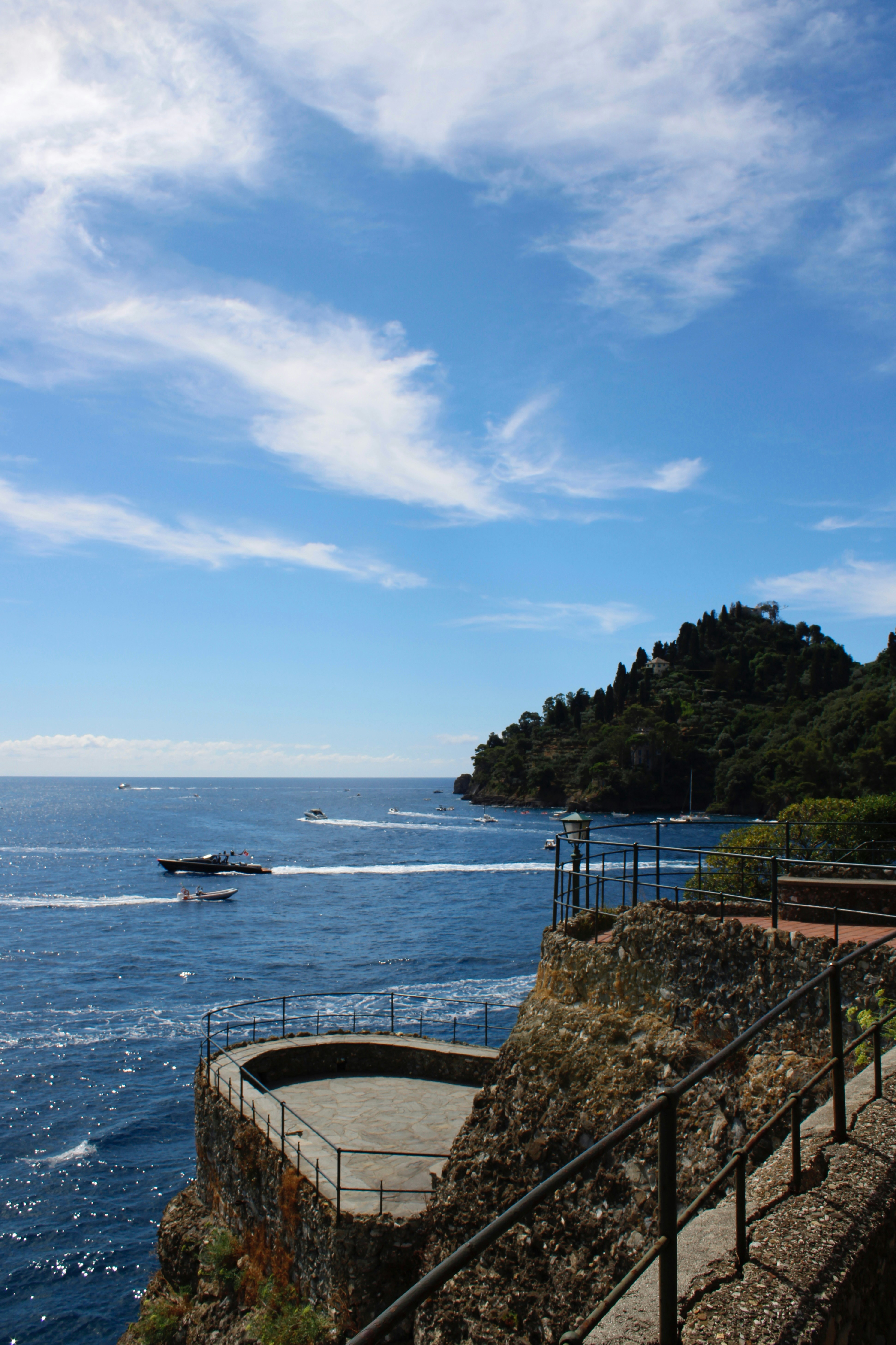 Beautiful ocean view with boats and a blue sky.
