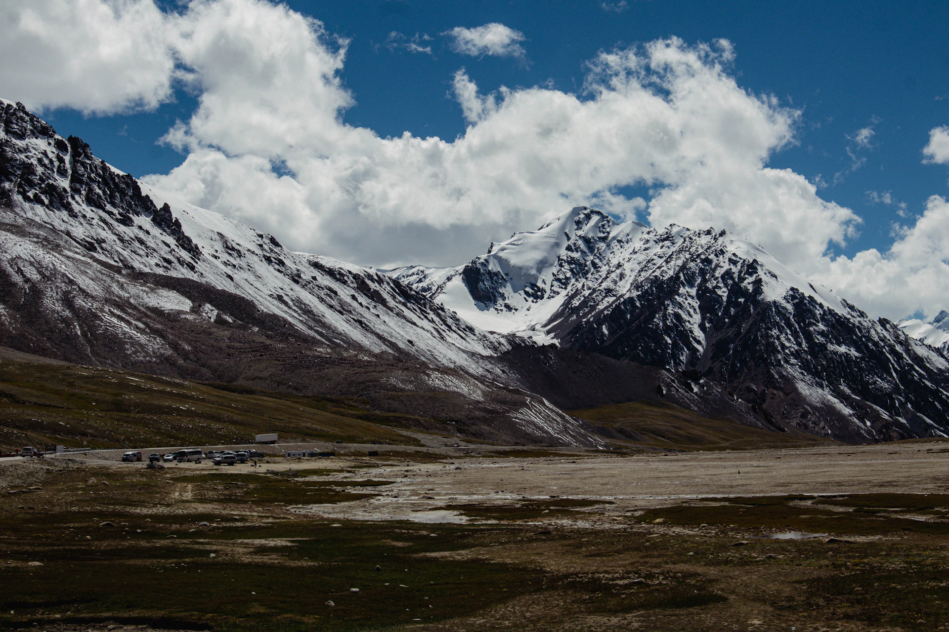 Snowy mountains under a beautiful, cloudy sky.