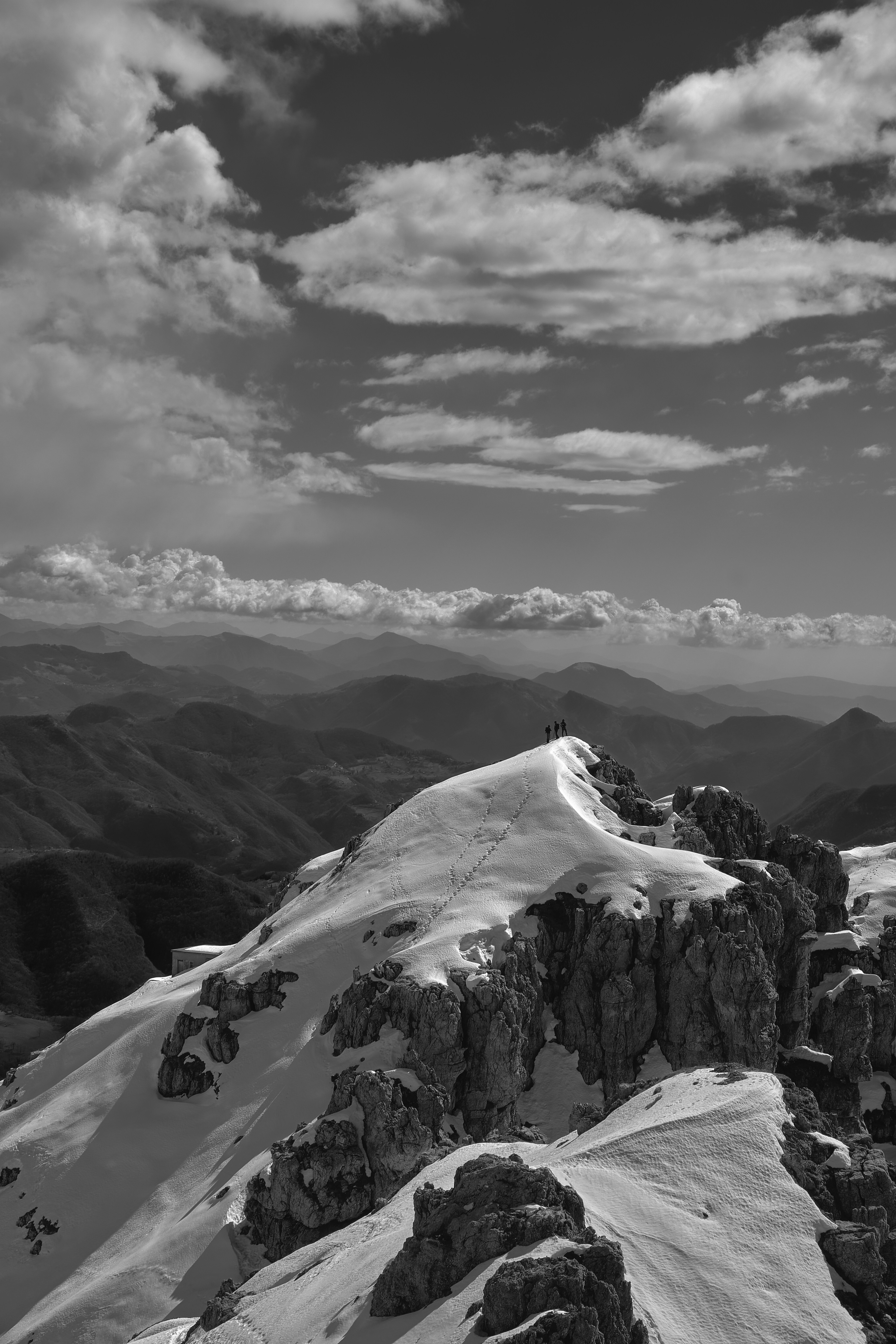 Snowy mountain peak under a cloudy sky.