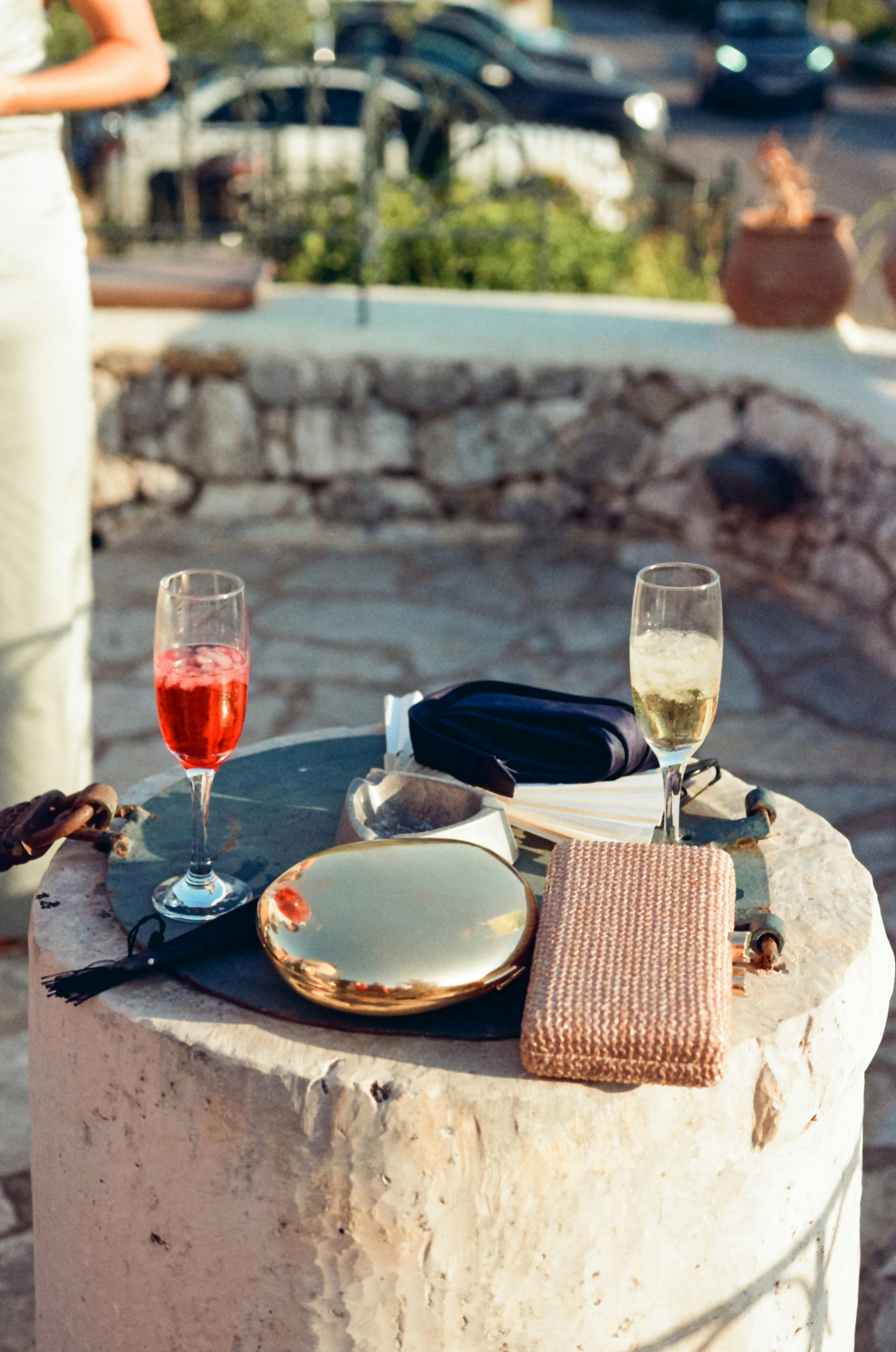 Drinks and accessories sit on a stone table.