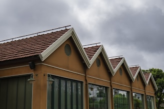A row of buildings has a sawtooth roof.