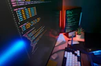 Coding code on multiple computer screens.