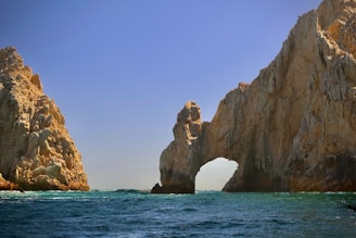The arch is framed by cliffs in turquoise waters.