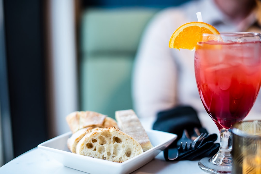Cocktail and bread on a restaurant table.