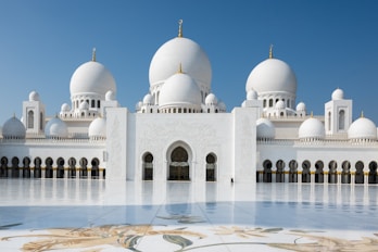 A beautiful white mosque stands tall and grand.