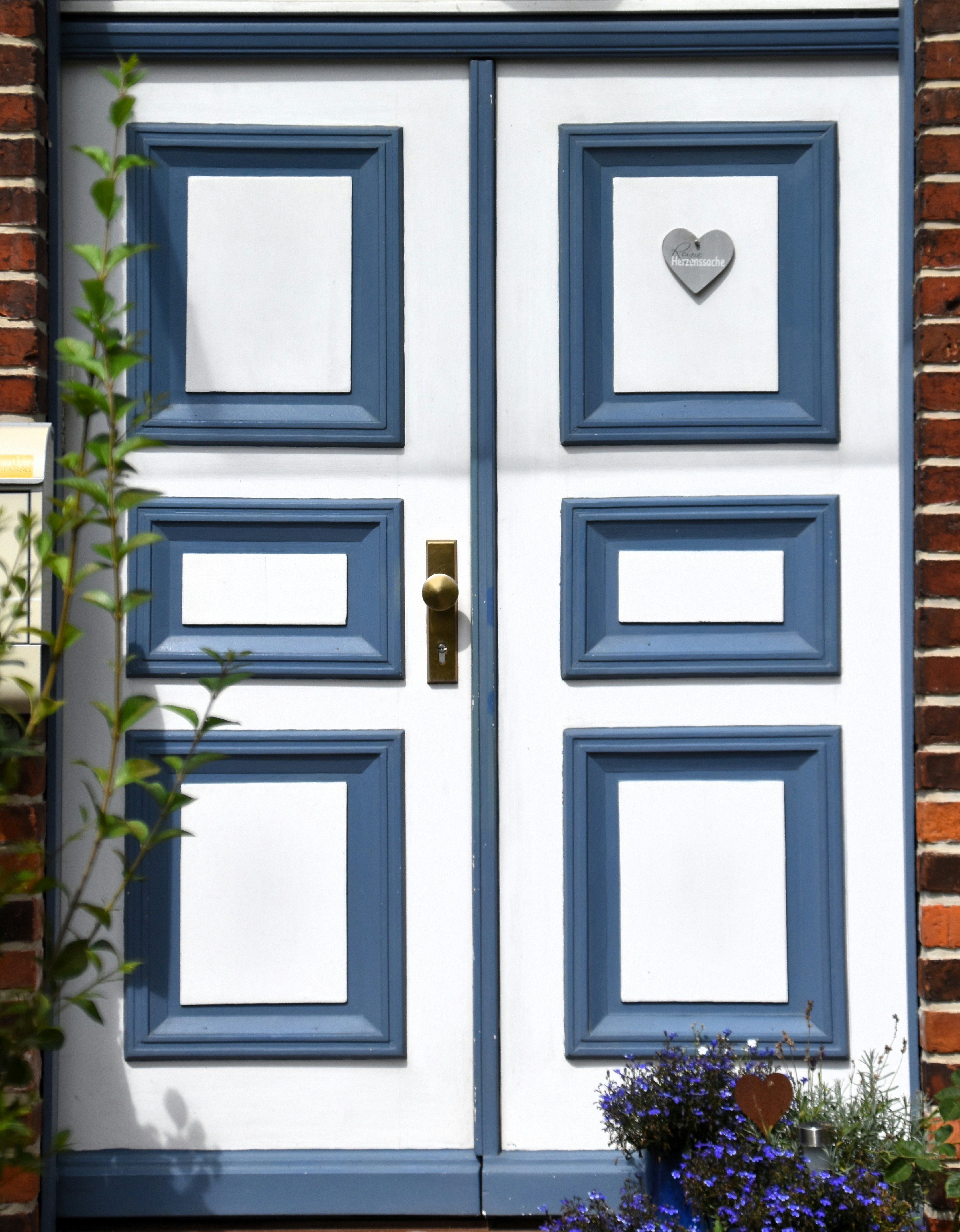 A white door with blue trim and a heart.