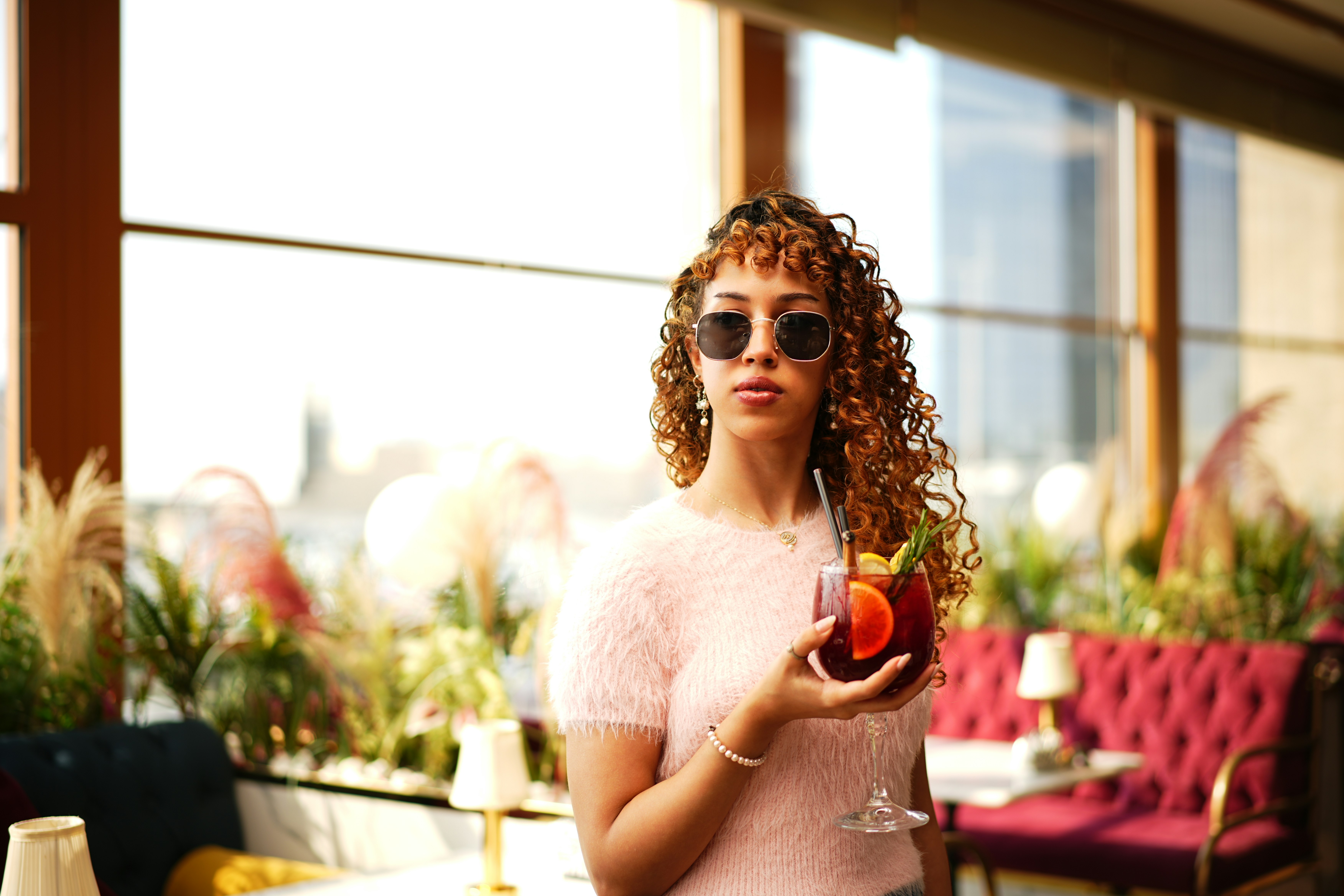 Woman enjoys a drink while looking cool.