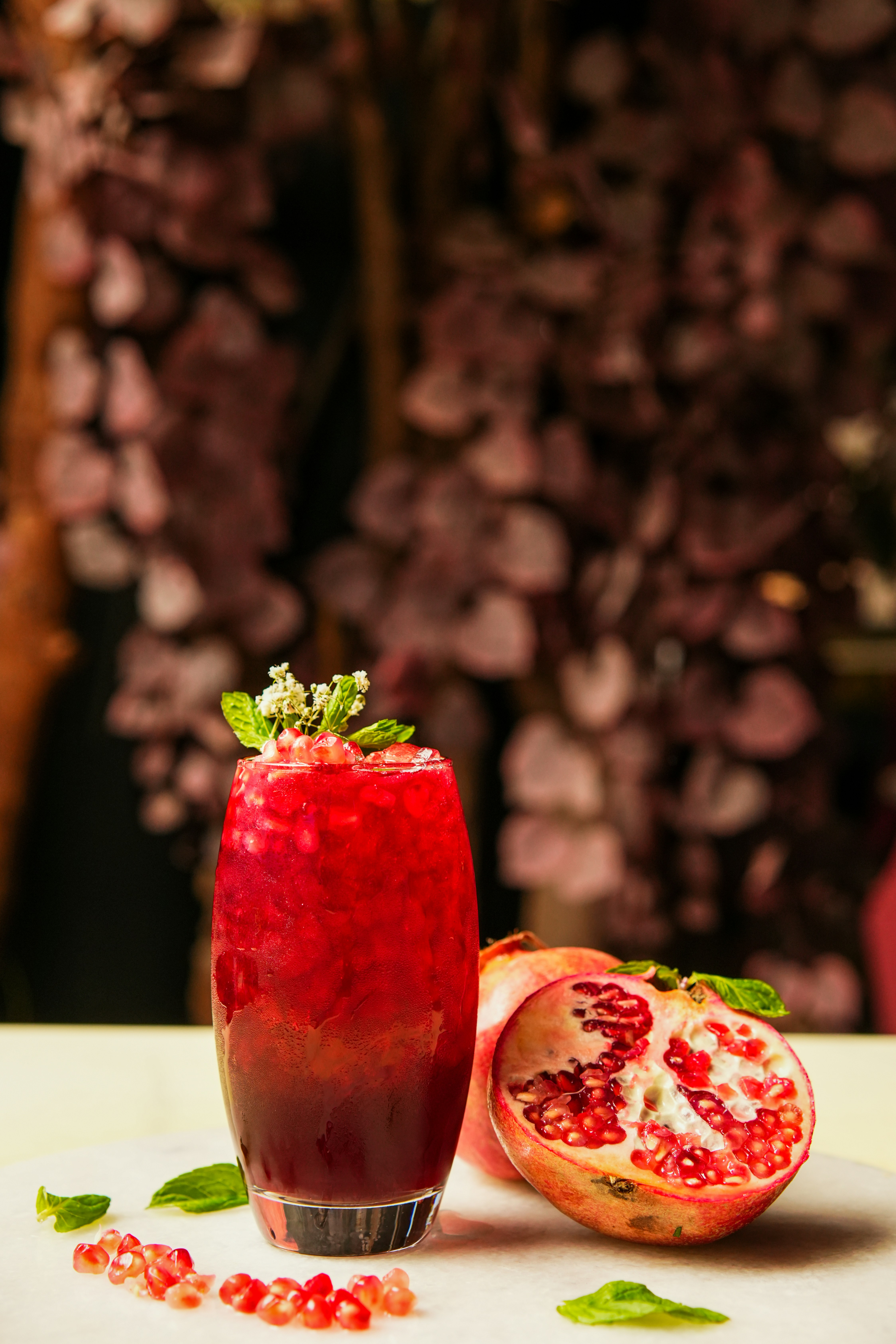 Pomegranate juice served with a cut pomegranate.