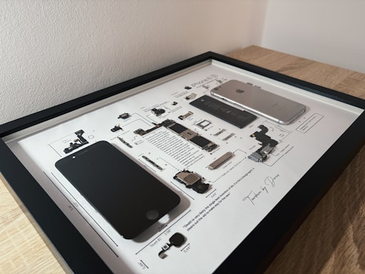 An iPhone is disassembled and framed.