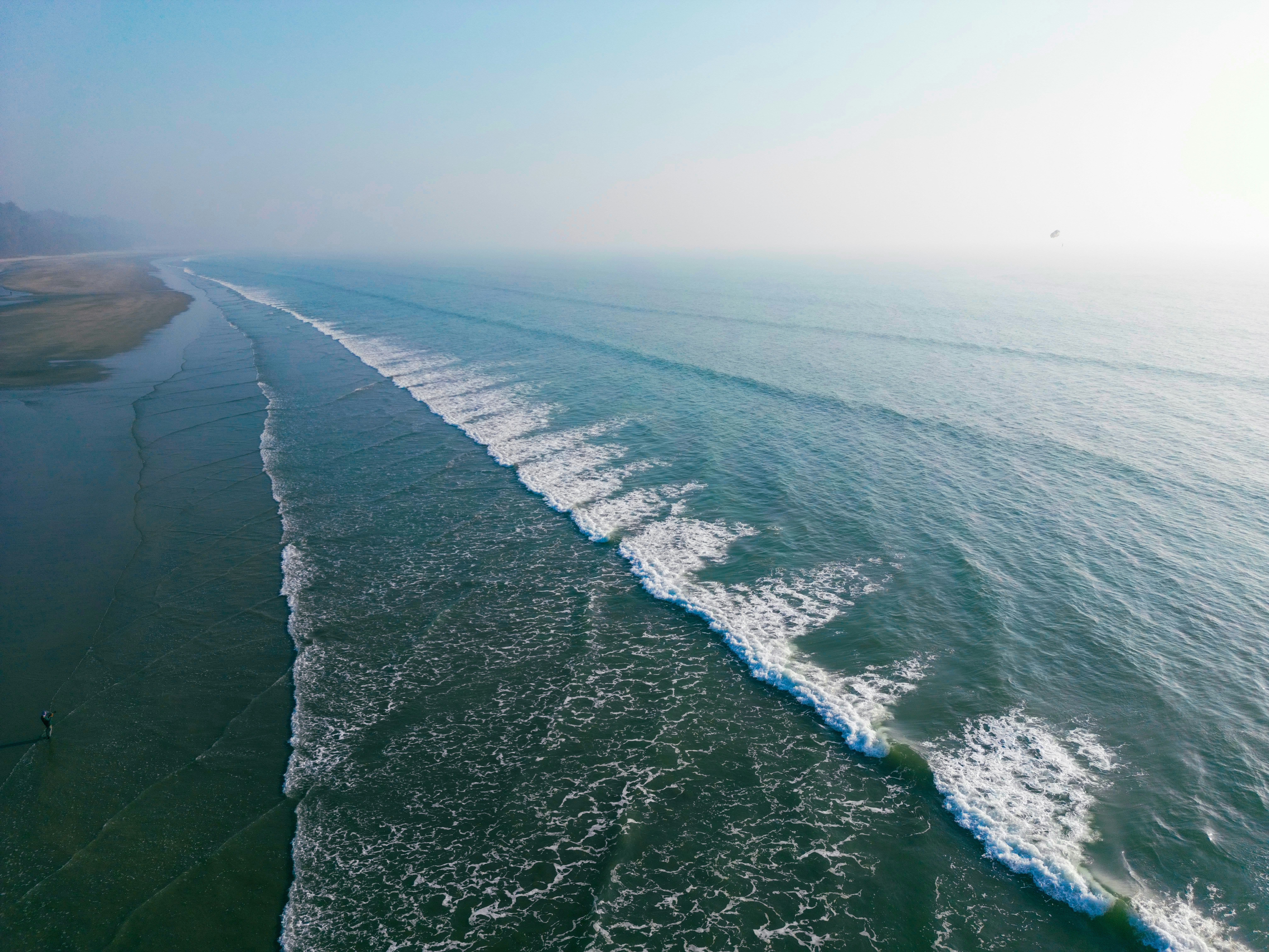 Waves crash along a sandy beach.
